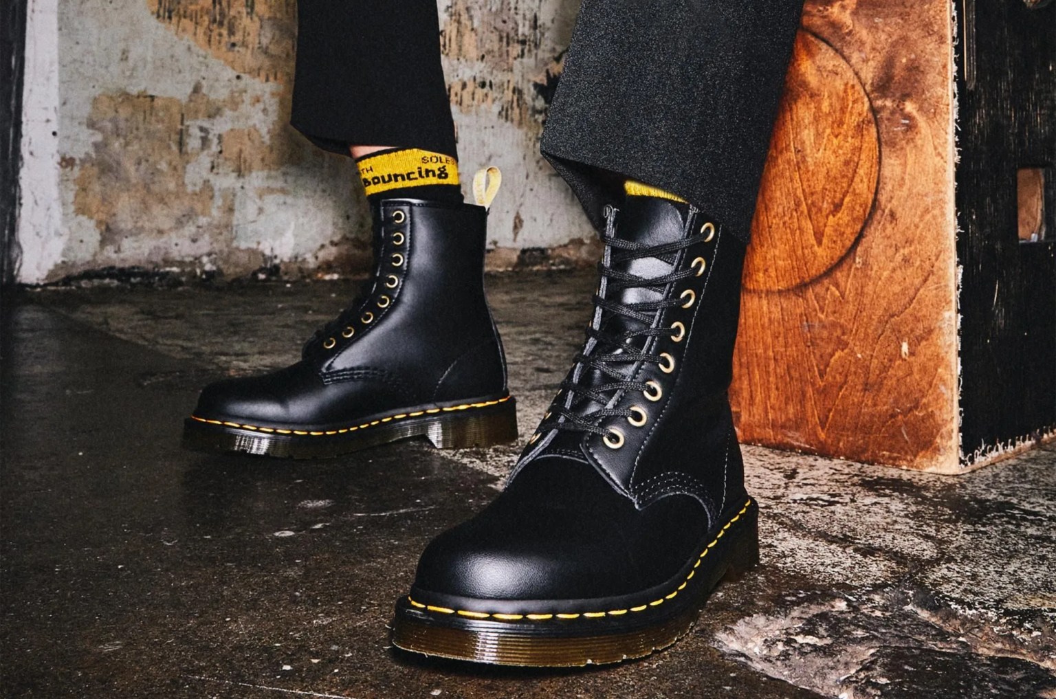 person wearing black doc martens boots