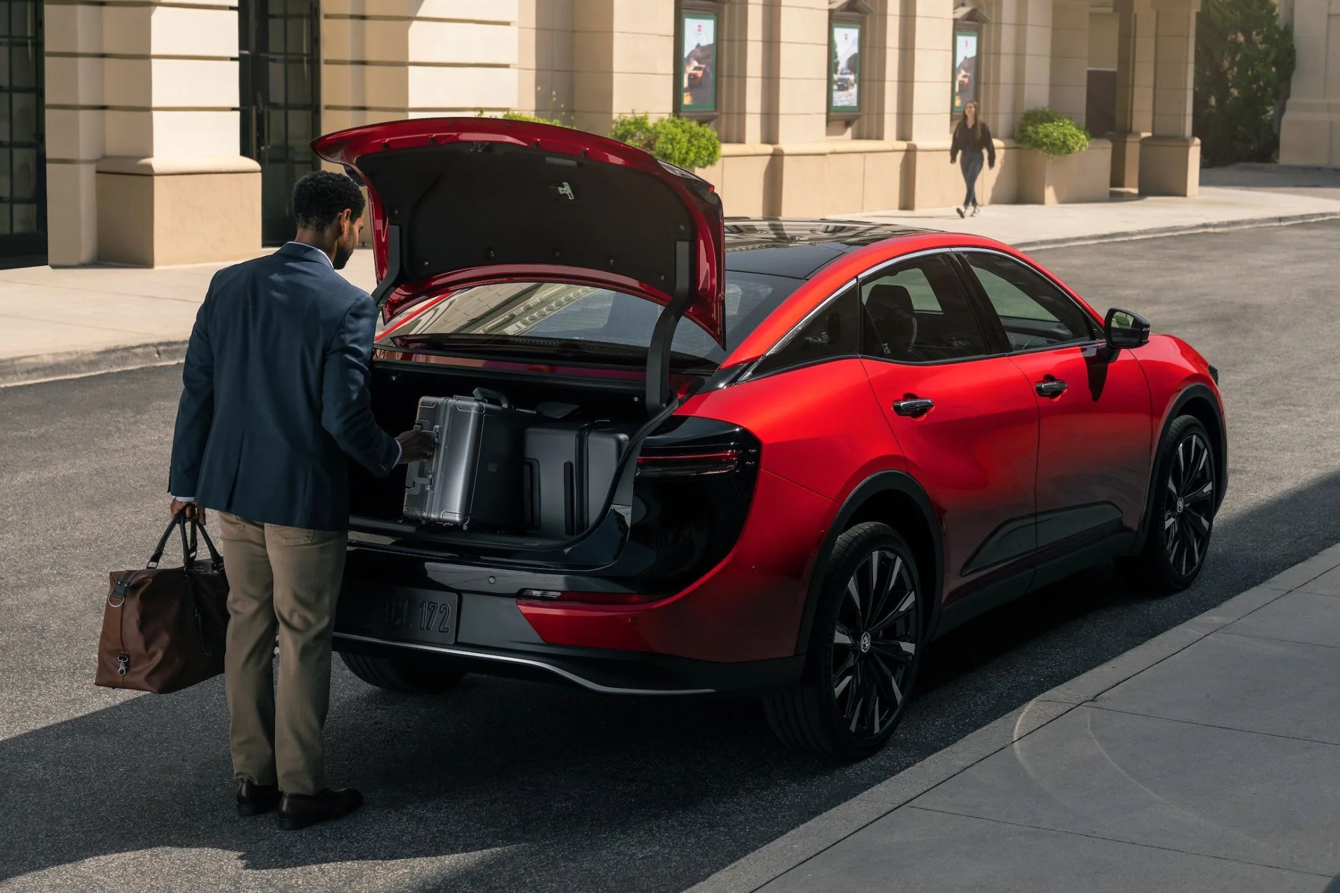 rendered shot of the new toyota crown sedan from the rear with the trunk open