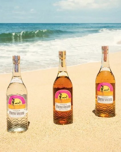 tequila eterno verano bottles on the beach