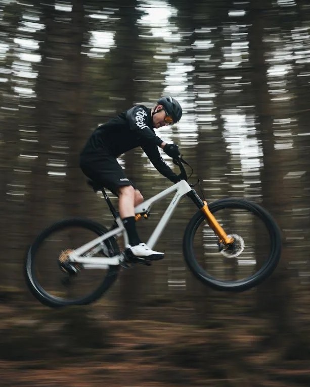 man riding allebike alpha polestar edition through forest