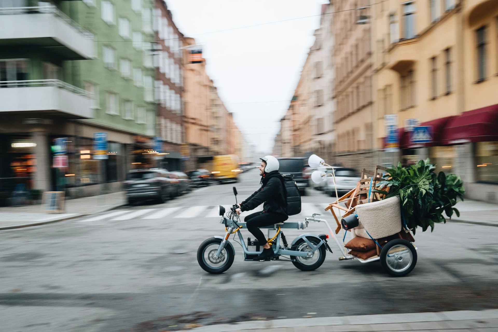 someone pulling furniture on the back of the osa plus motorcycle