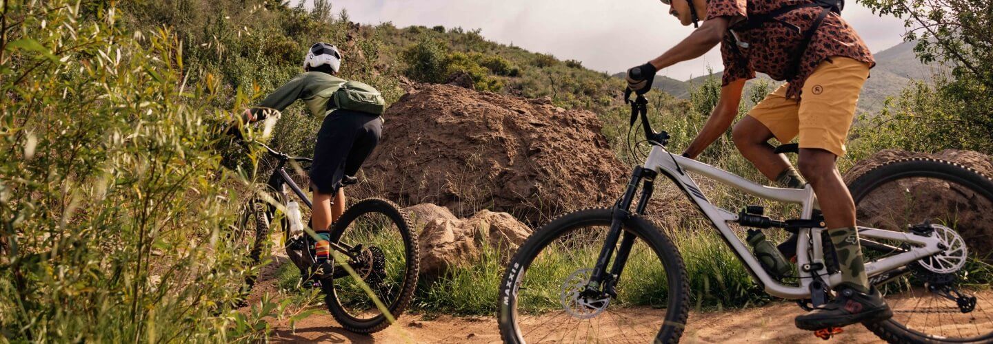 backcountry man riding on bike through dirt road