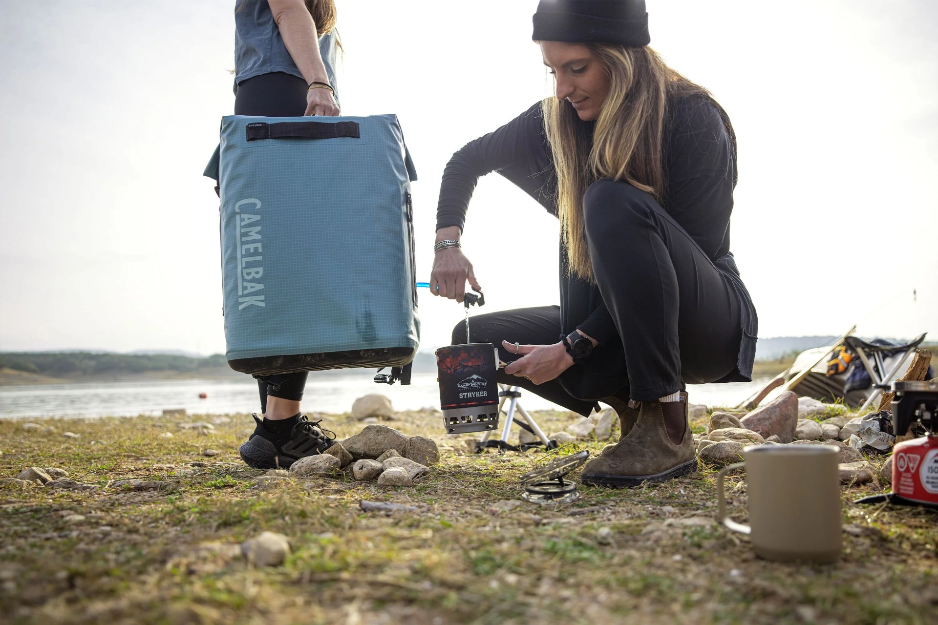 woman using the hydration reservoir spigot attachment on the camelback chillbak backpack cooler