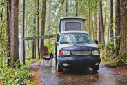 camper van with awning parked at campsite