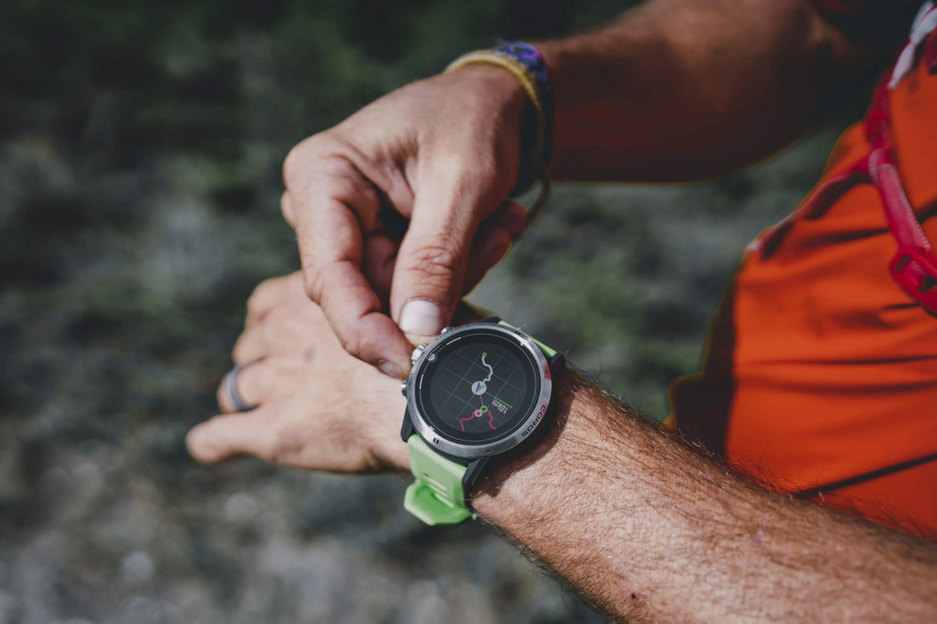 someone adjusting their coros apex pro watch