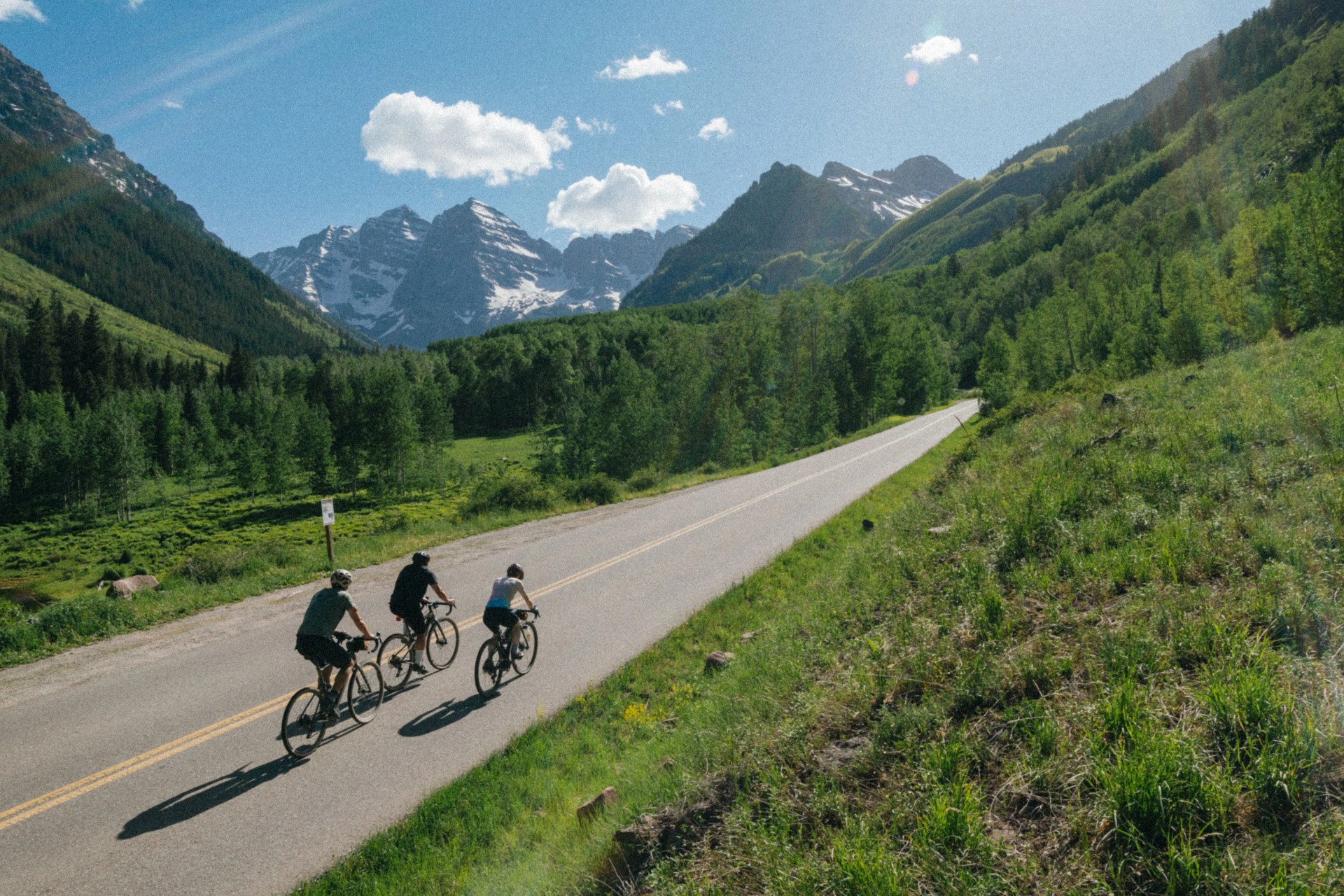 three people riding bikes