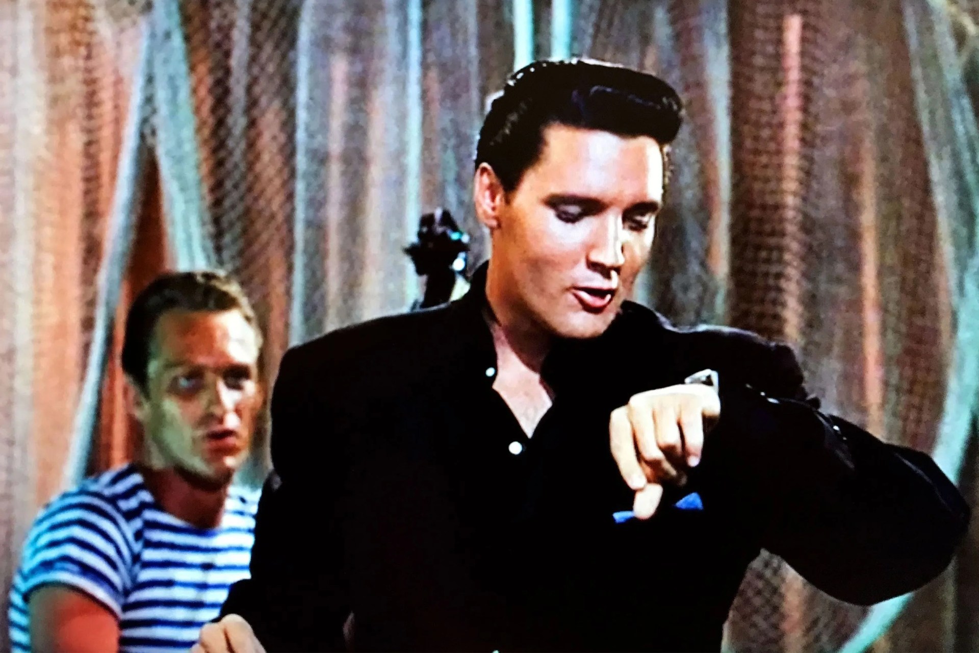 elvis presley looking at a watch on his wrist