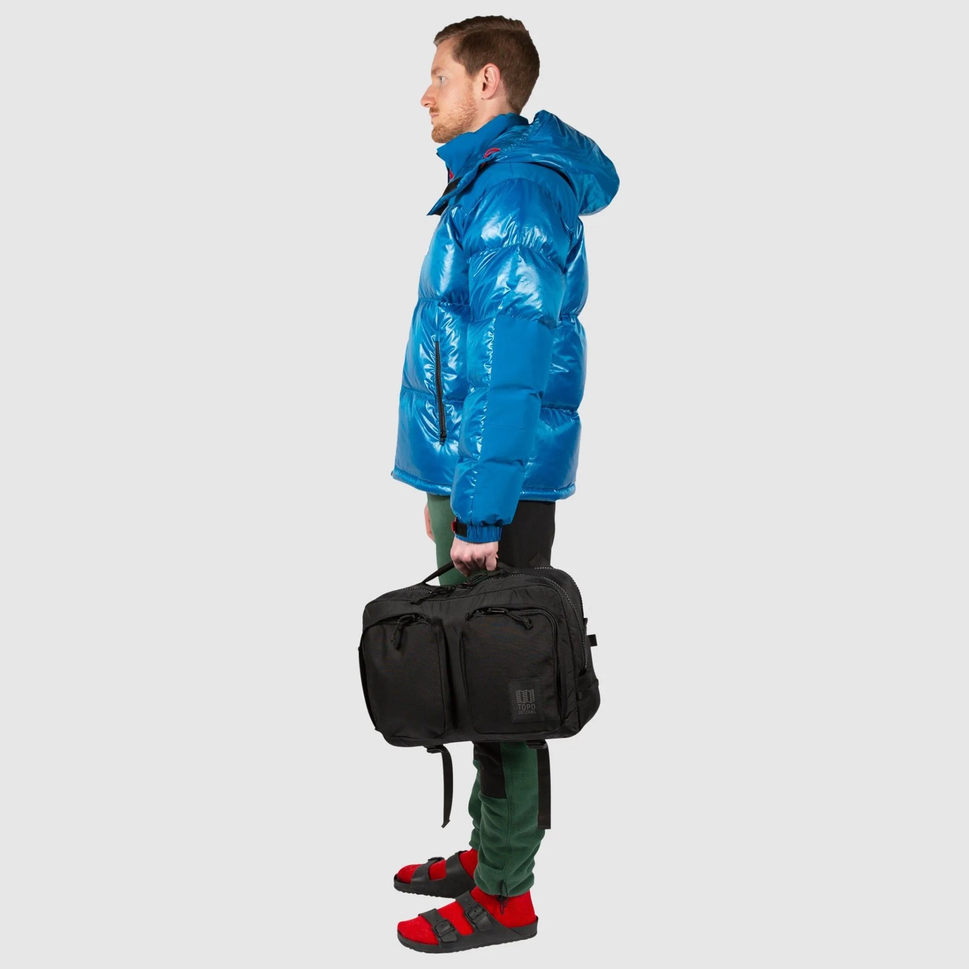 man carrying topo designs global briefcase in black