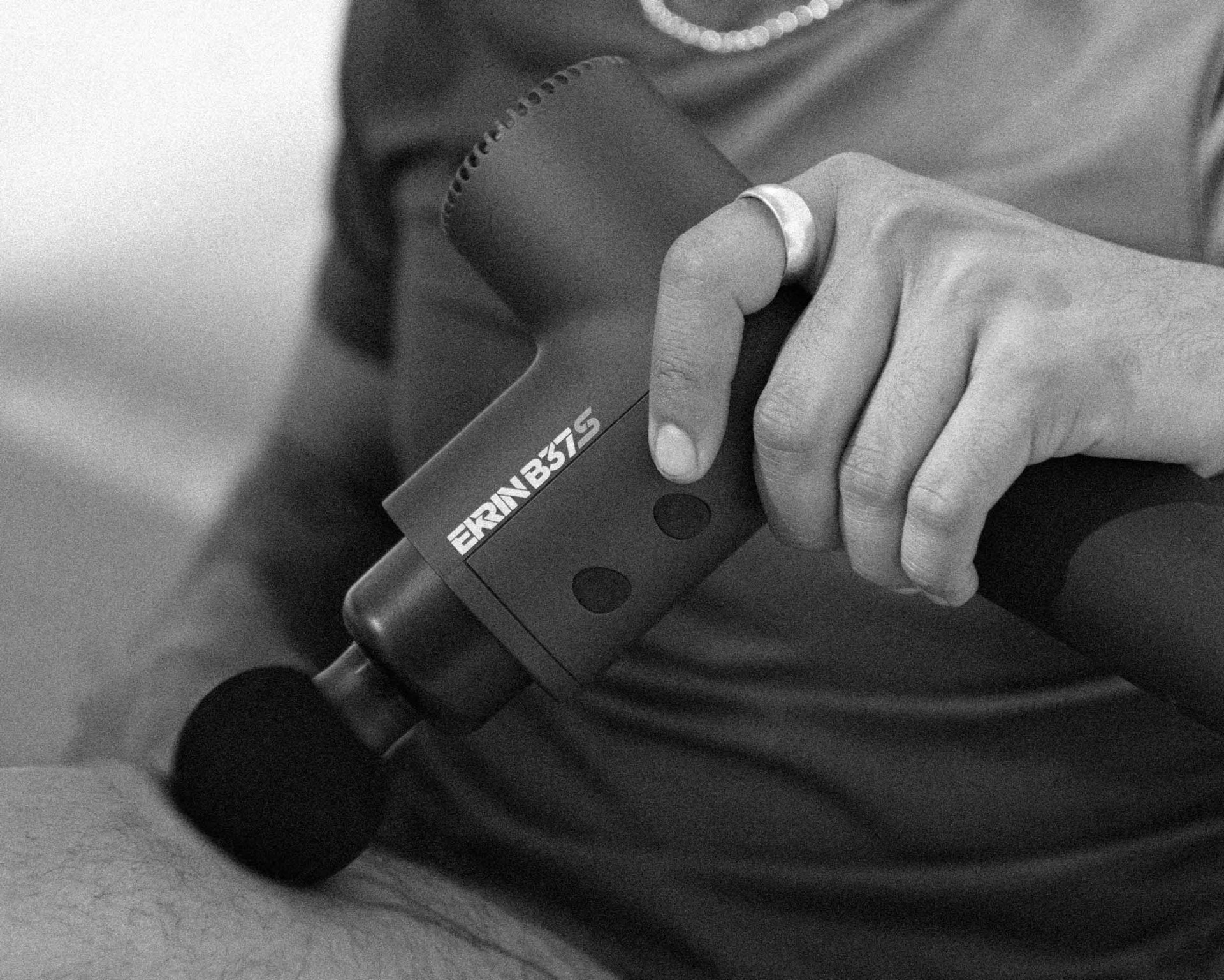 man using a massage gun