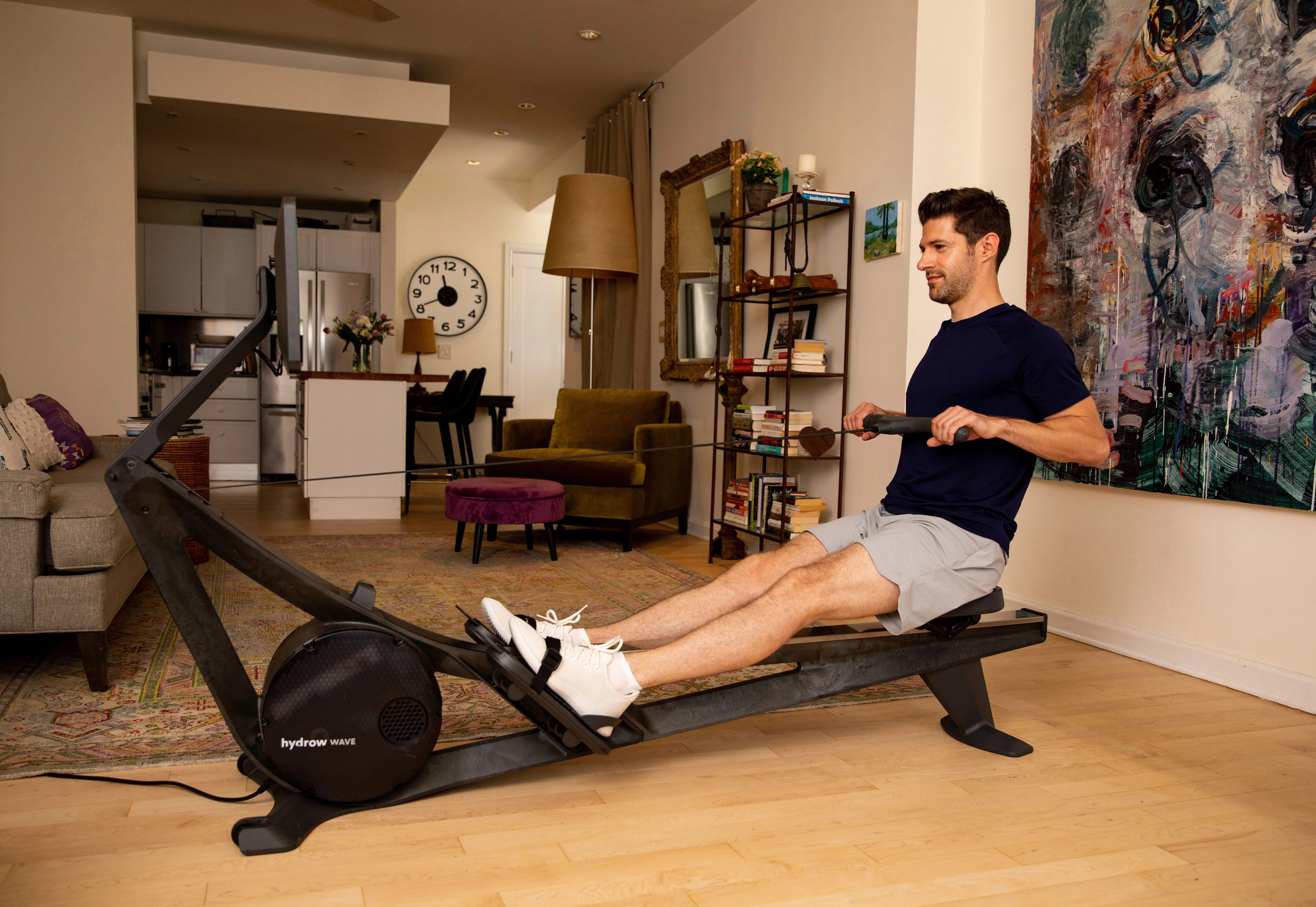 man using a home rowing workout machine