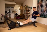 man using a home rowing workout machine