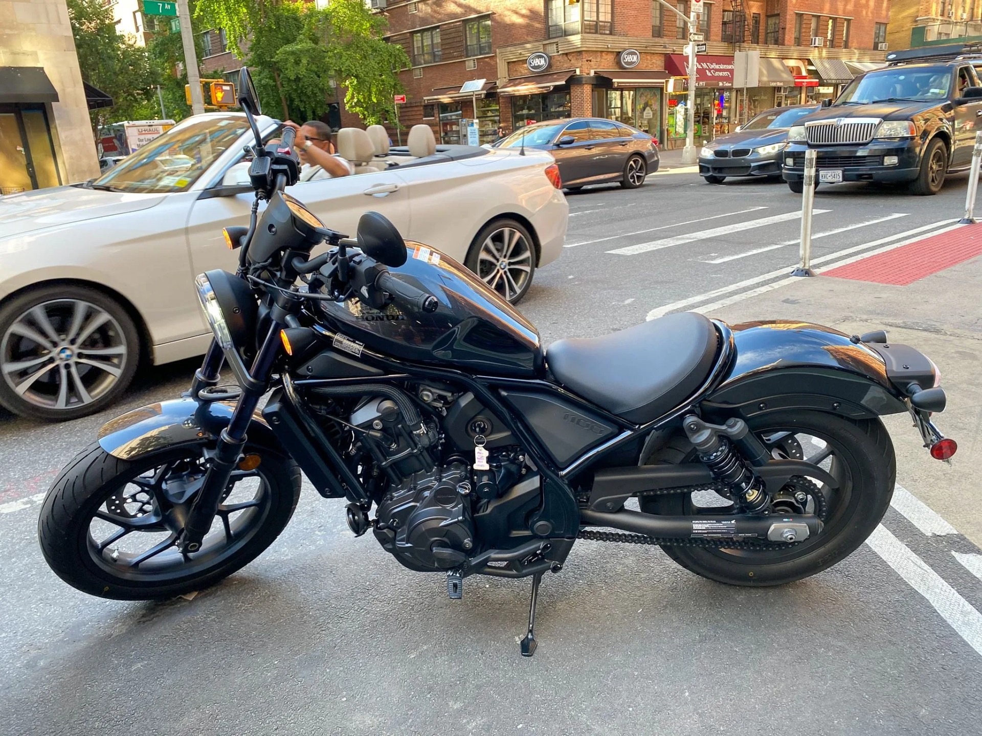 black honda rebel 1100 parked on a sitting street