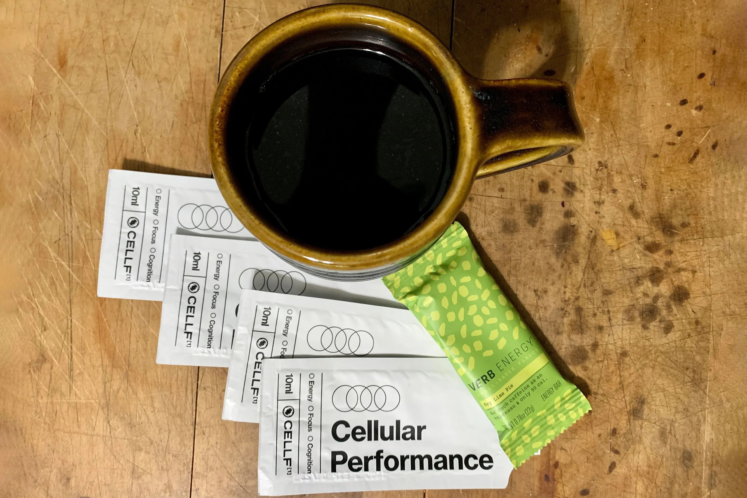 cup of coffee with granola bar and mikra cellf packets