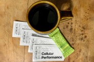cup of coffee with granola bar and mikra cellf packets