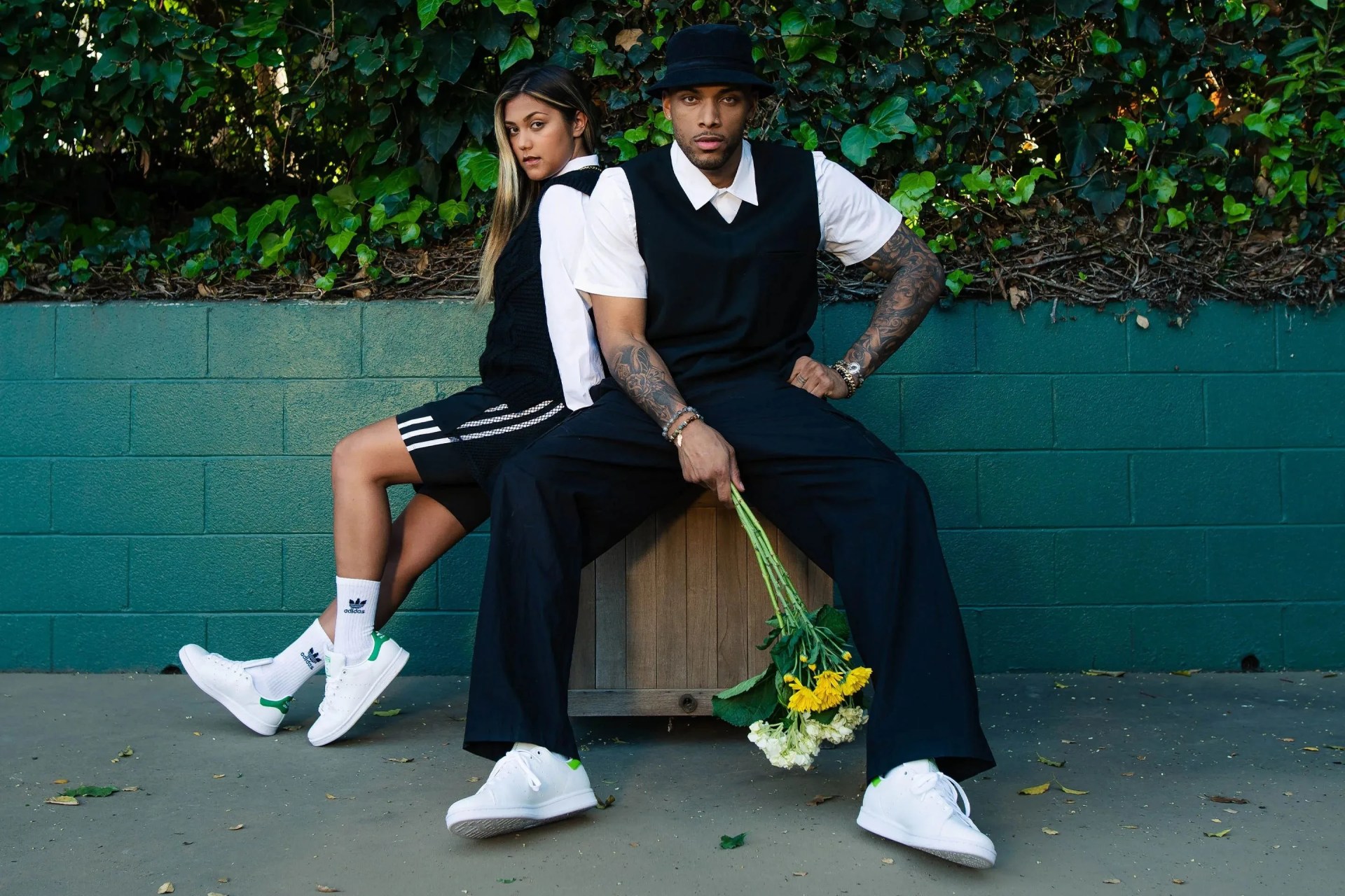 man and woman wearing adidas stan smith shoes