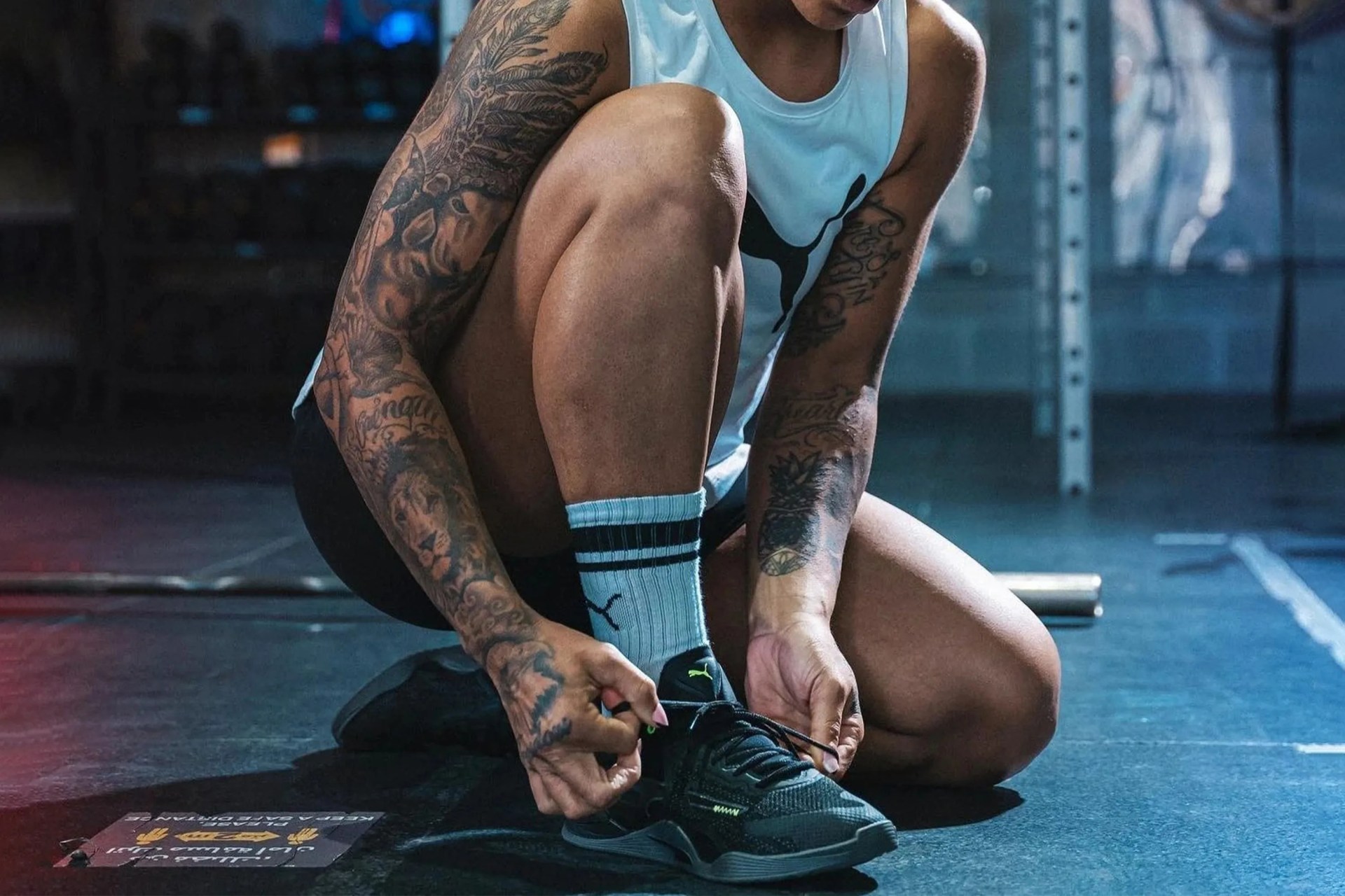 someone tying the laces on the puma fuse trainer shoe