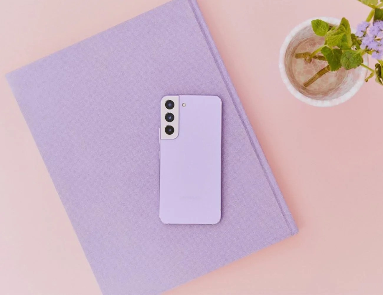 samsung galaxy s22 in the new ​​bora purple color laying on a book
