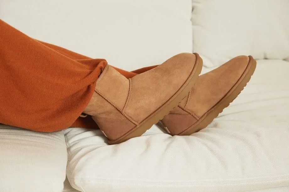 someone wearing ugg boots on a couch