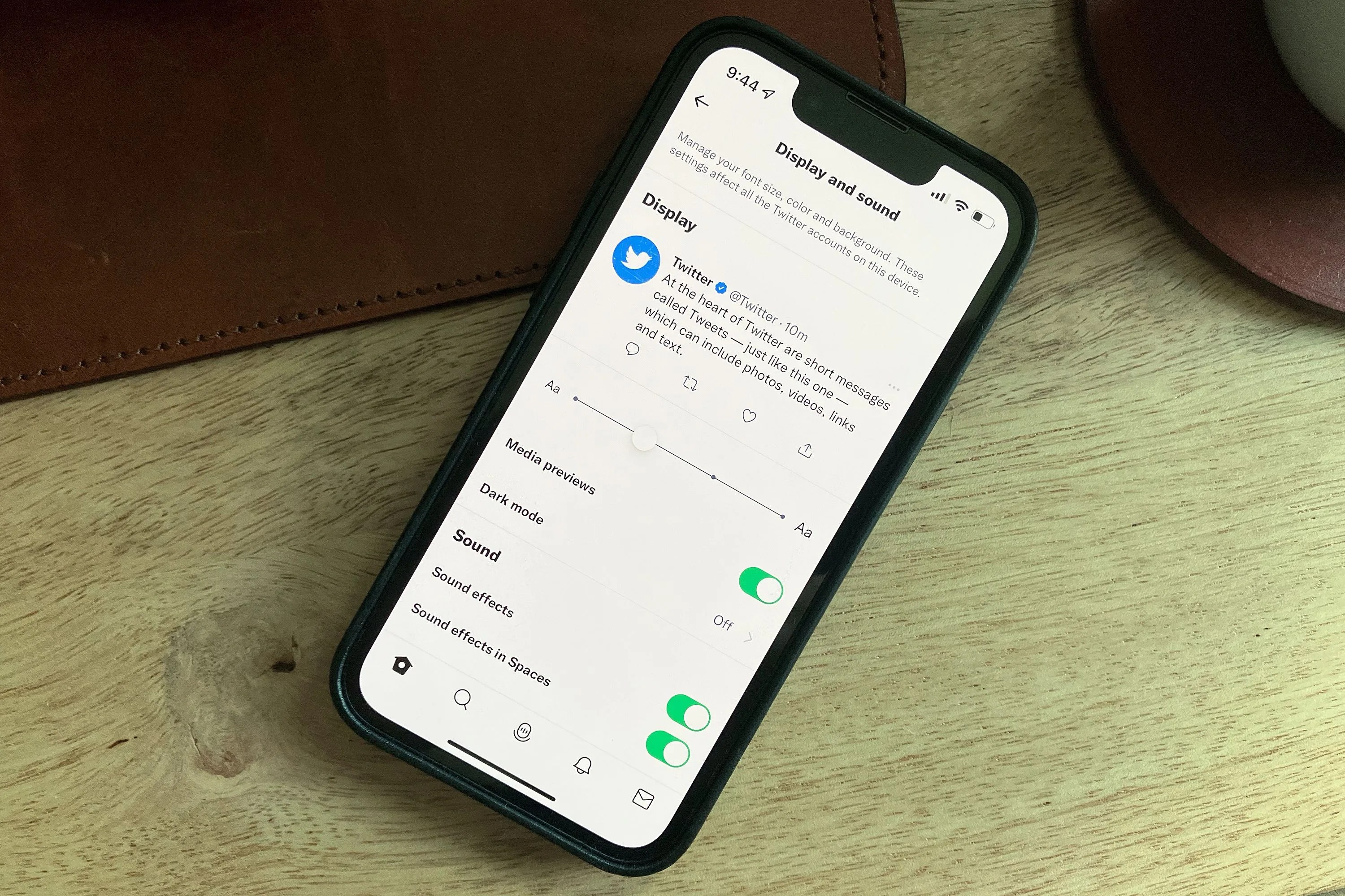 phone with twitter settings open sitting on a desk