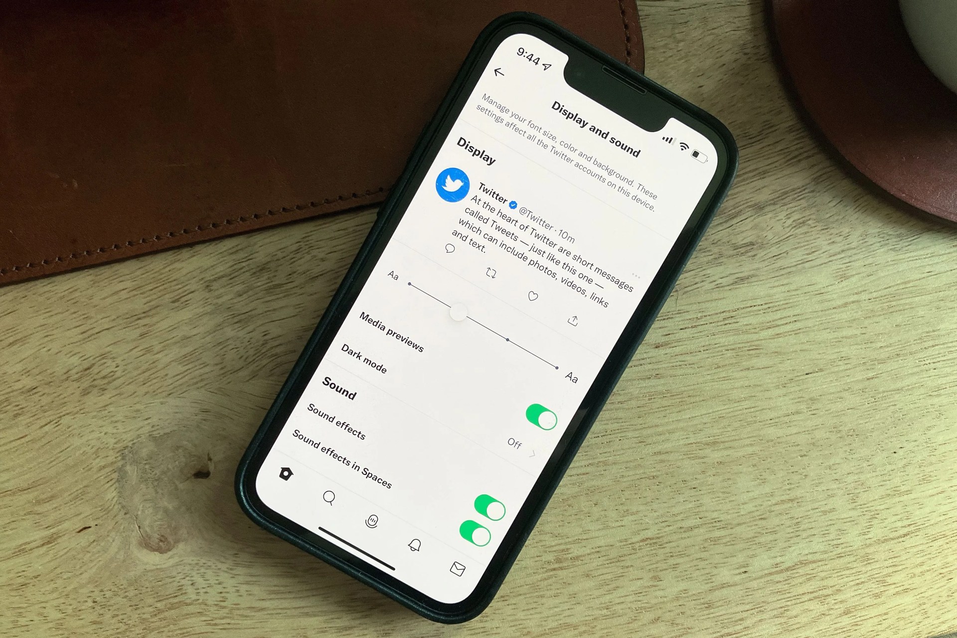phone with twitter settings open sitting on a desk