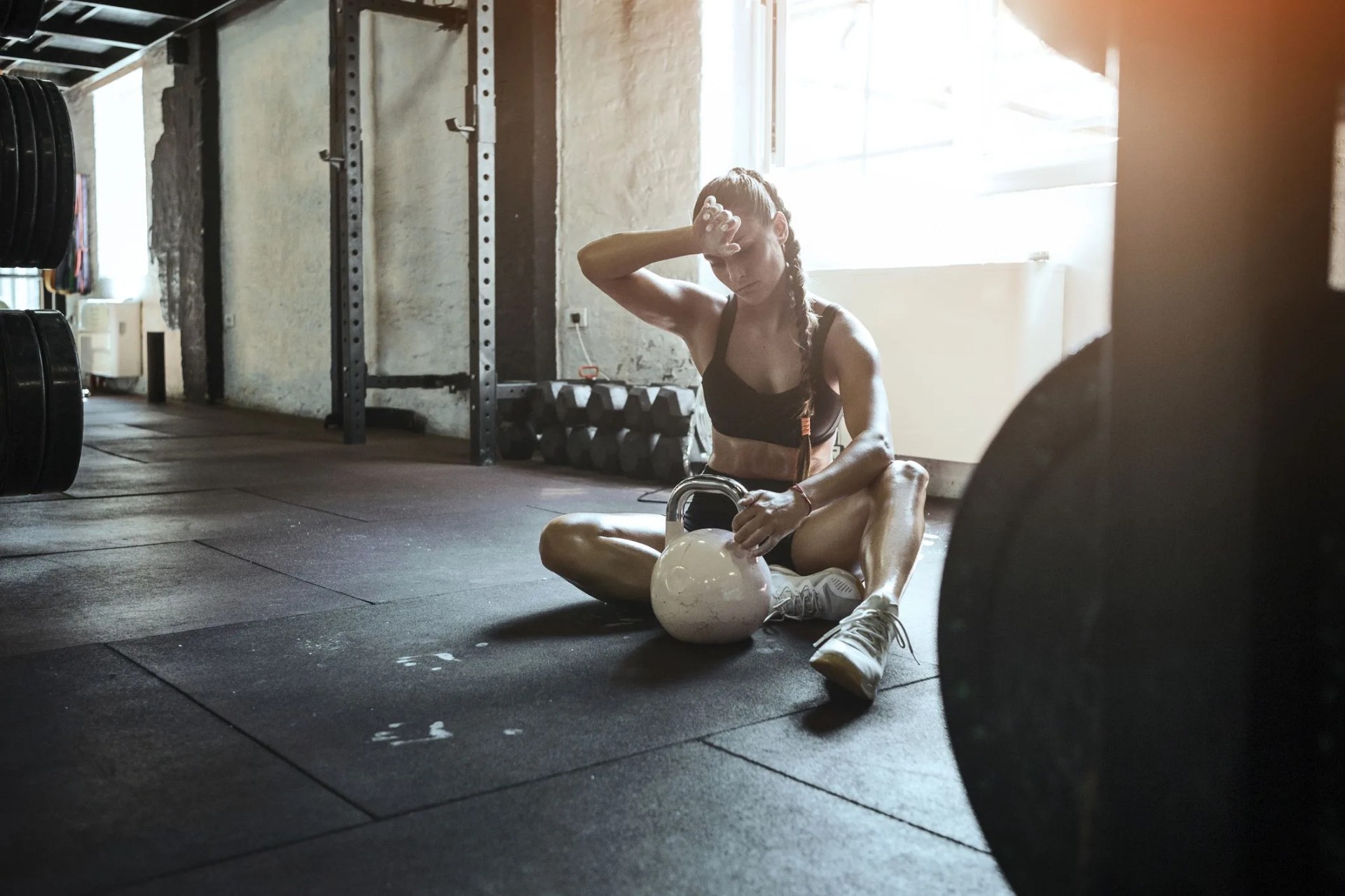 young fit woman exercise with kettle ball getting tired