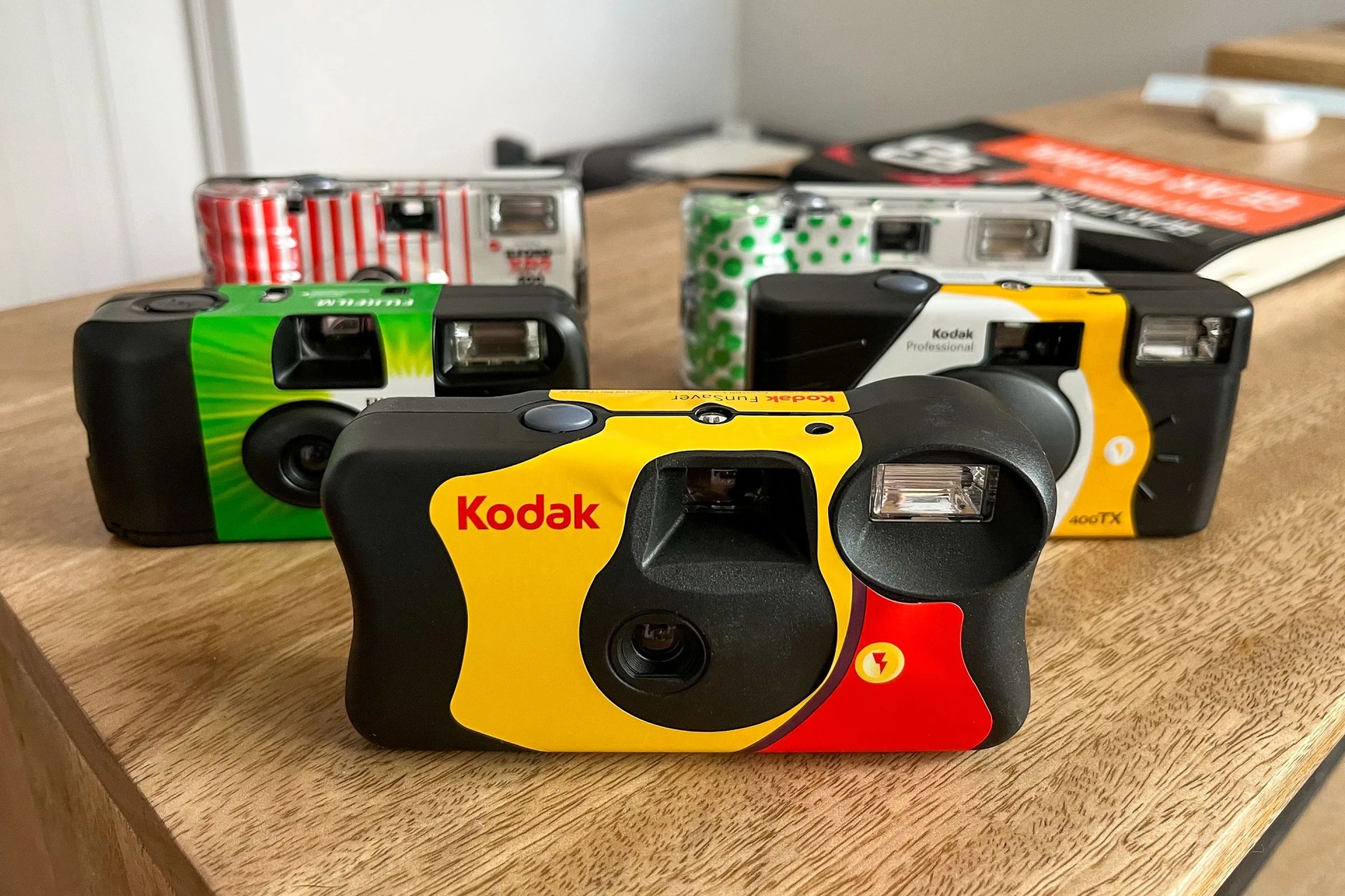 5 disposable cameras on a table