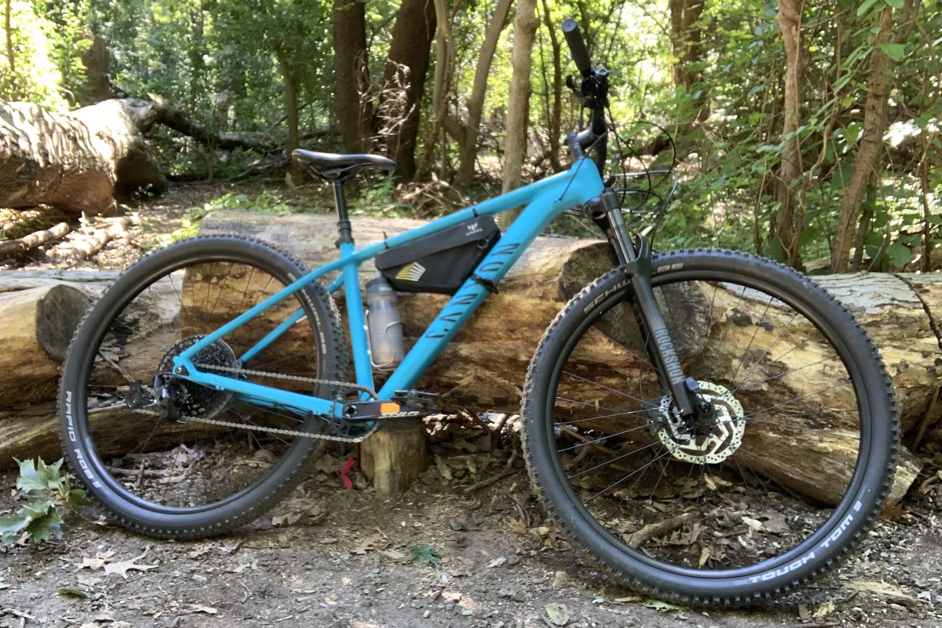 grand canyon 7 hardtail bike leaning against a tree stump