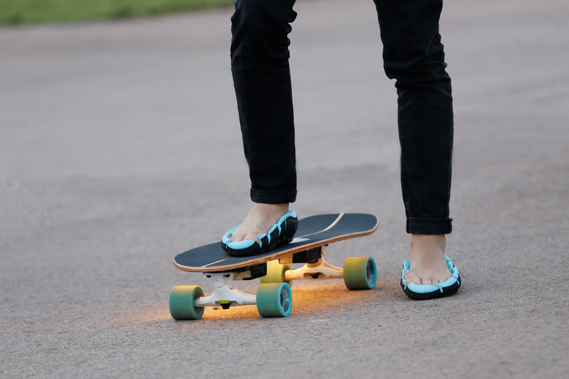 person wearing link flip shoes standing on skateboard