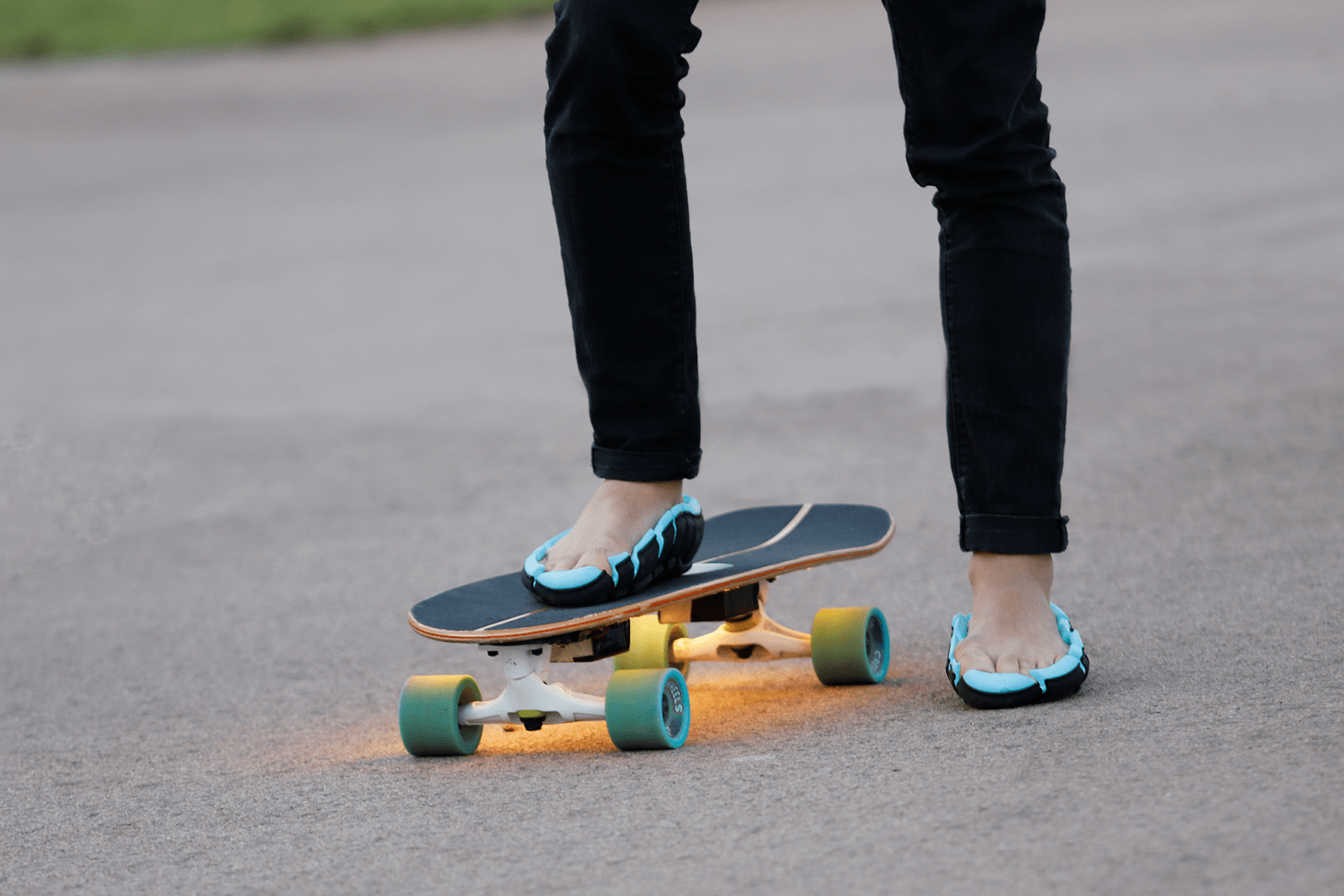 person wearing link flip shoes standing on skateboard