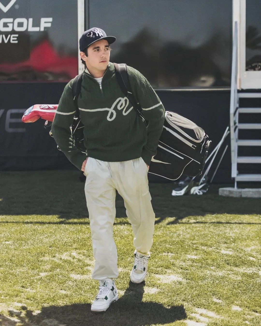 man walking with golf equipment