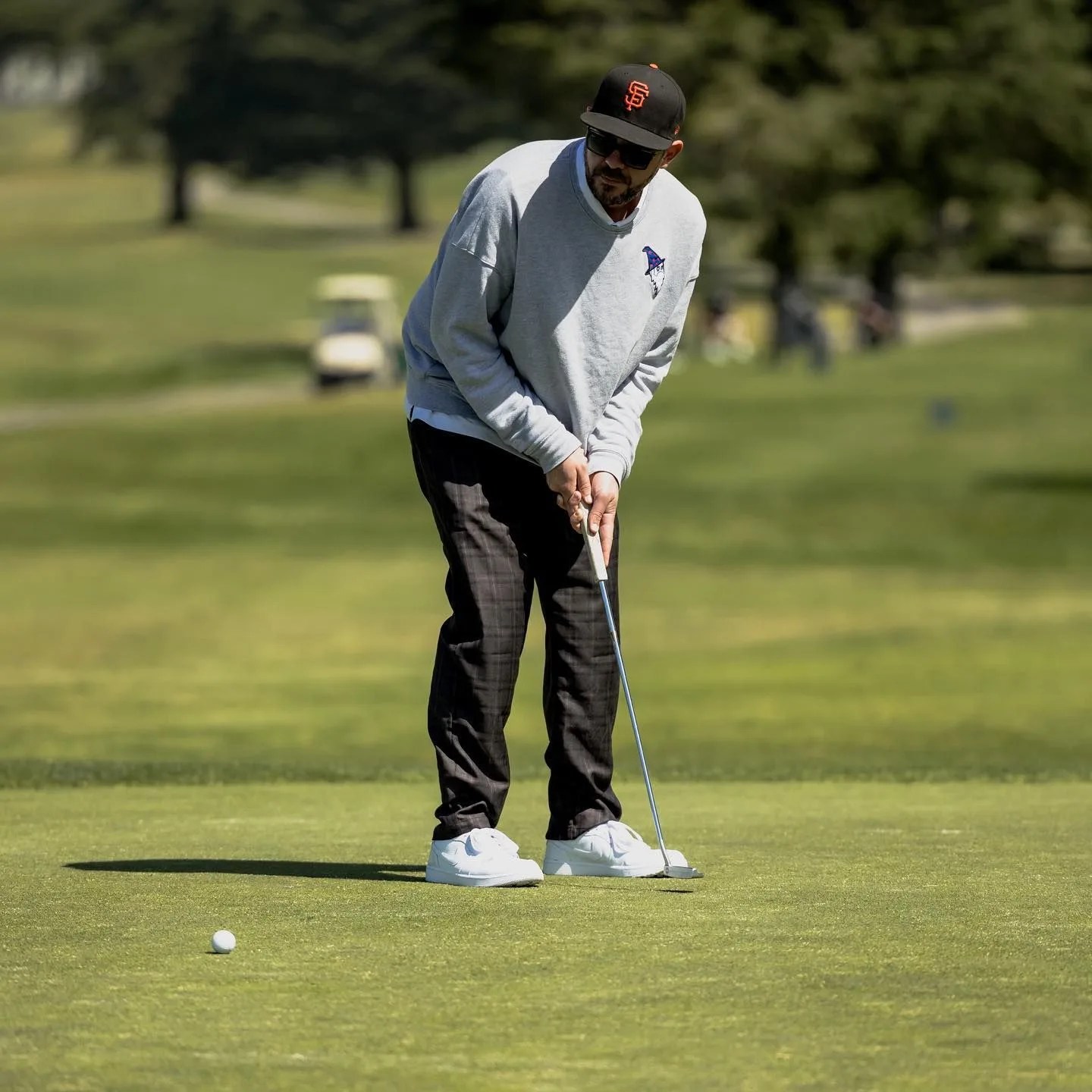 man putting a golf ball
