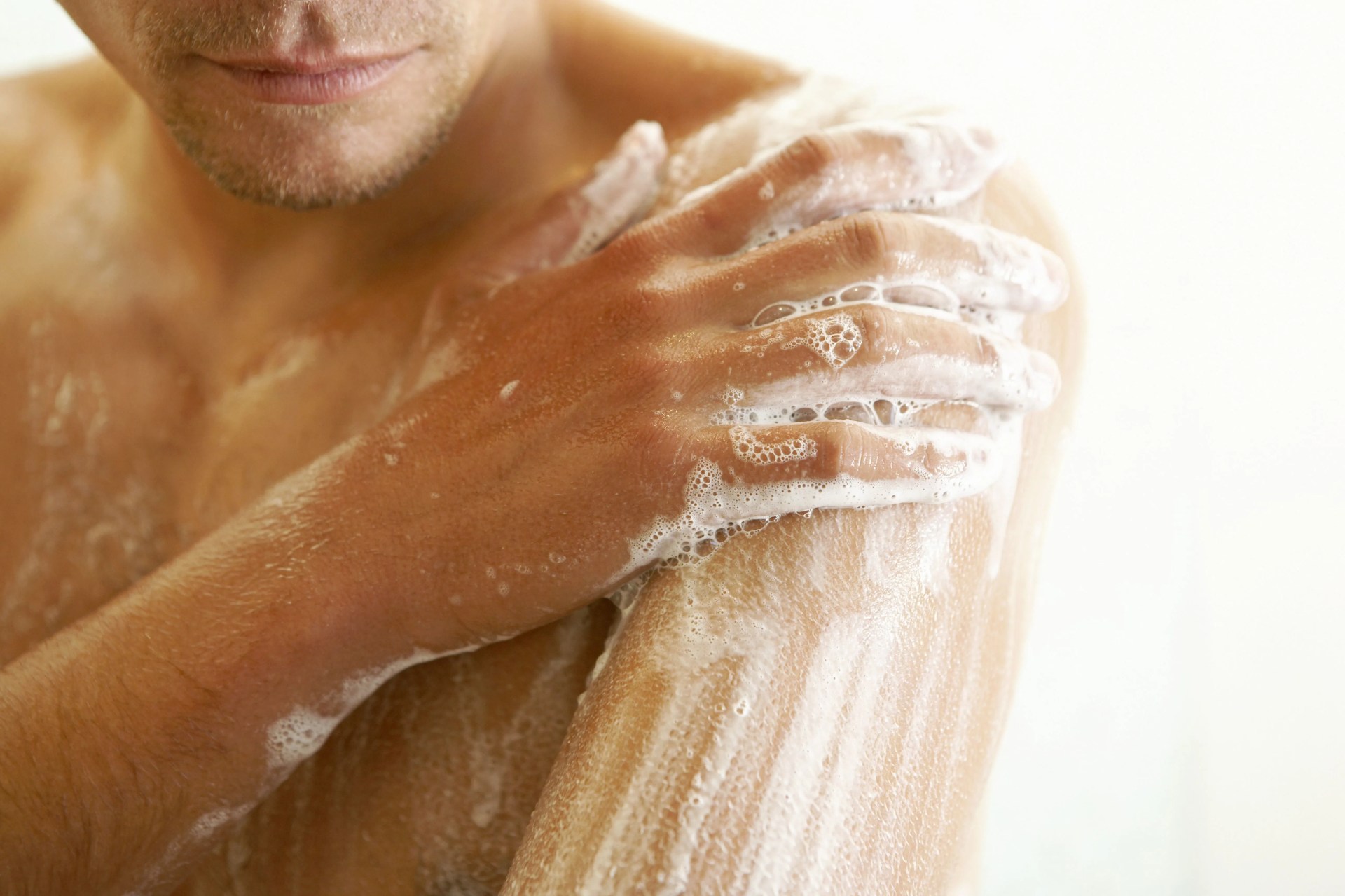 man soaping himself