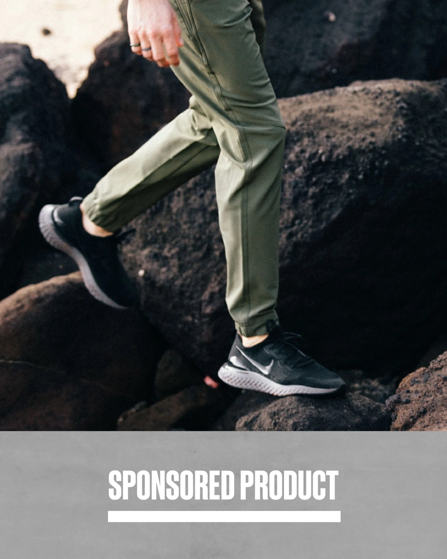 sponsored product man walking over rocks wearing tentree joggers