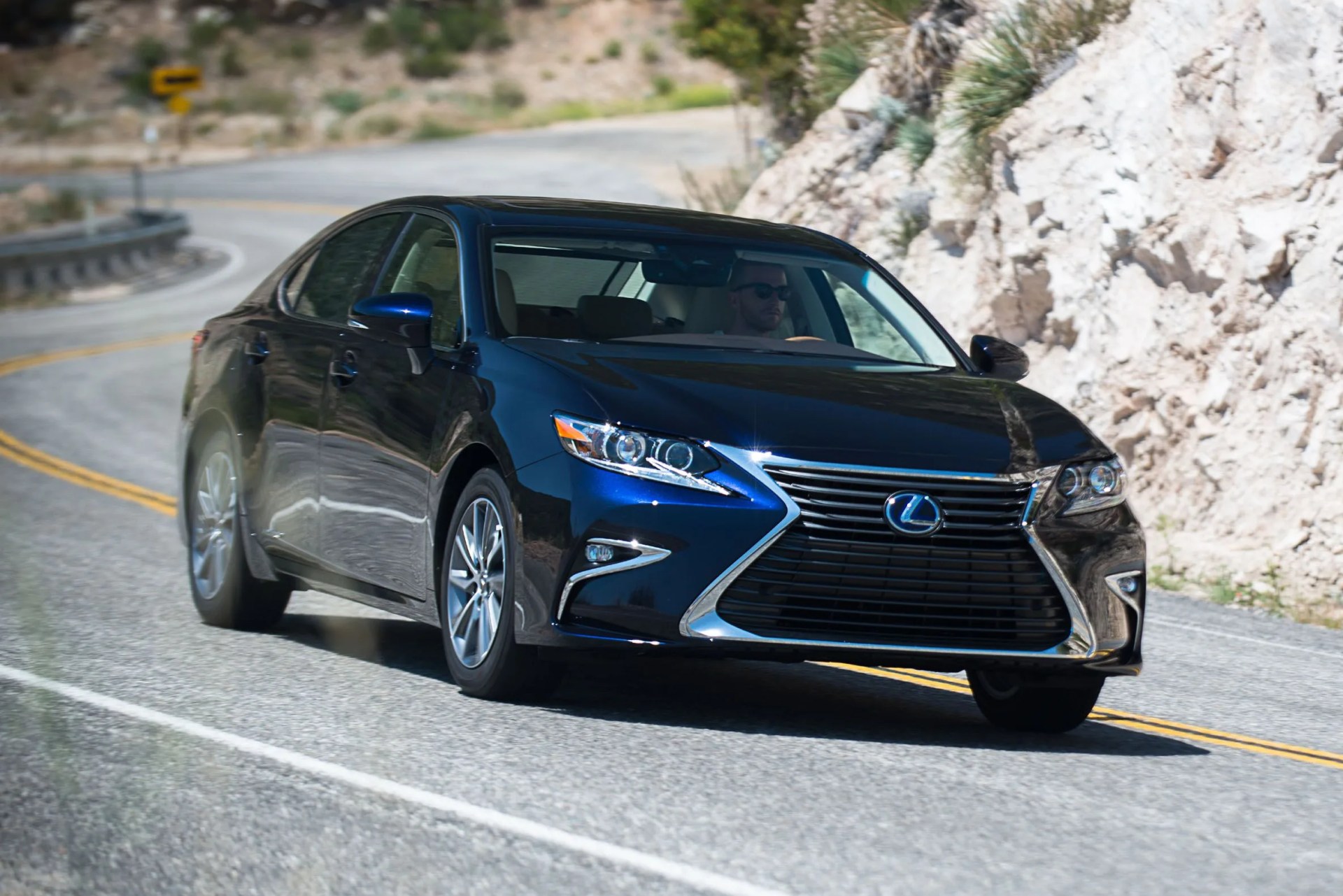 lexus es hybrid driving on a curvy mountain road