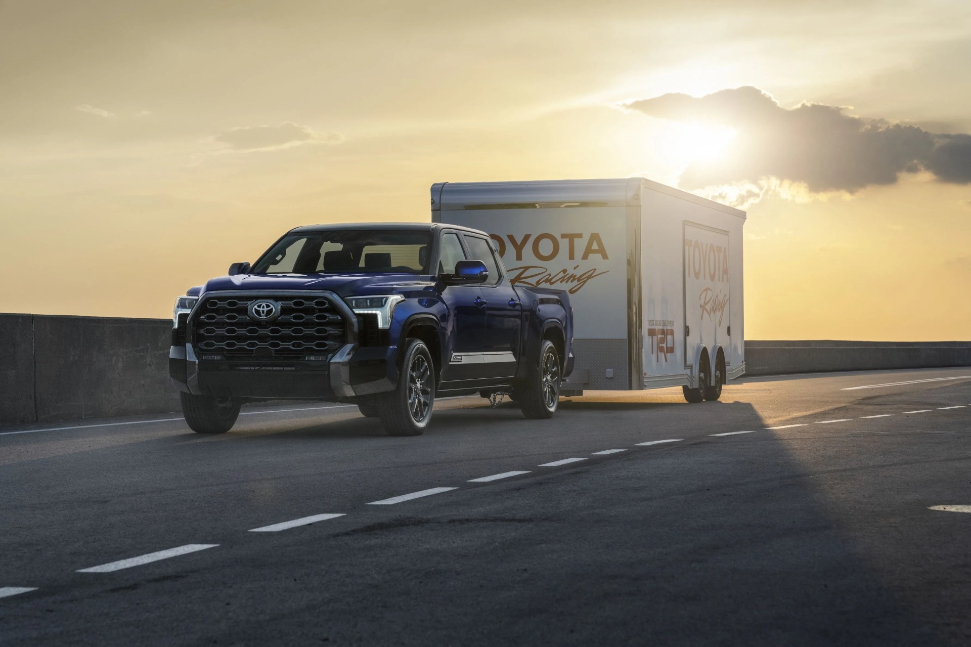 toyota tundra towing a toyota racing trailer on the highway