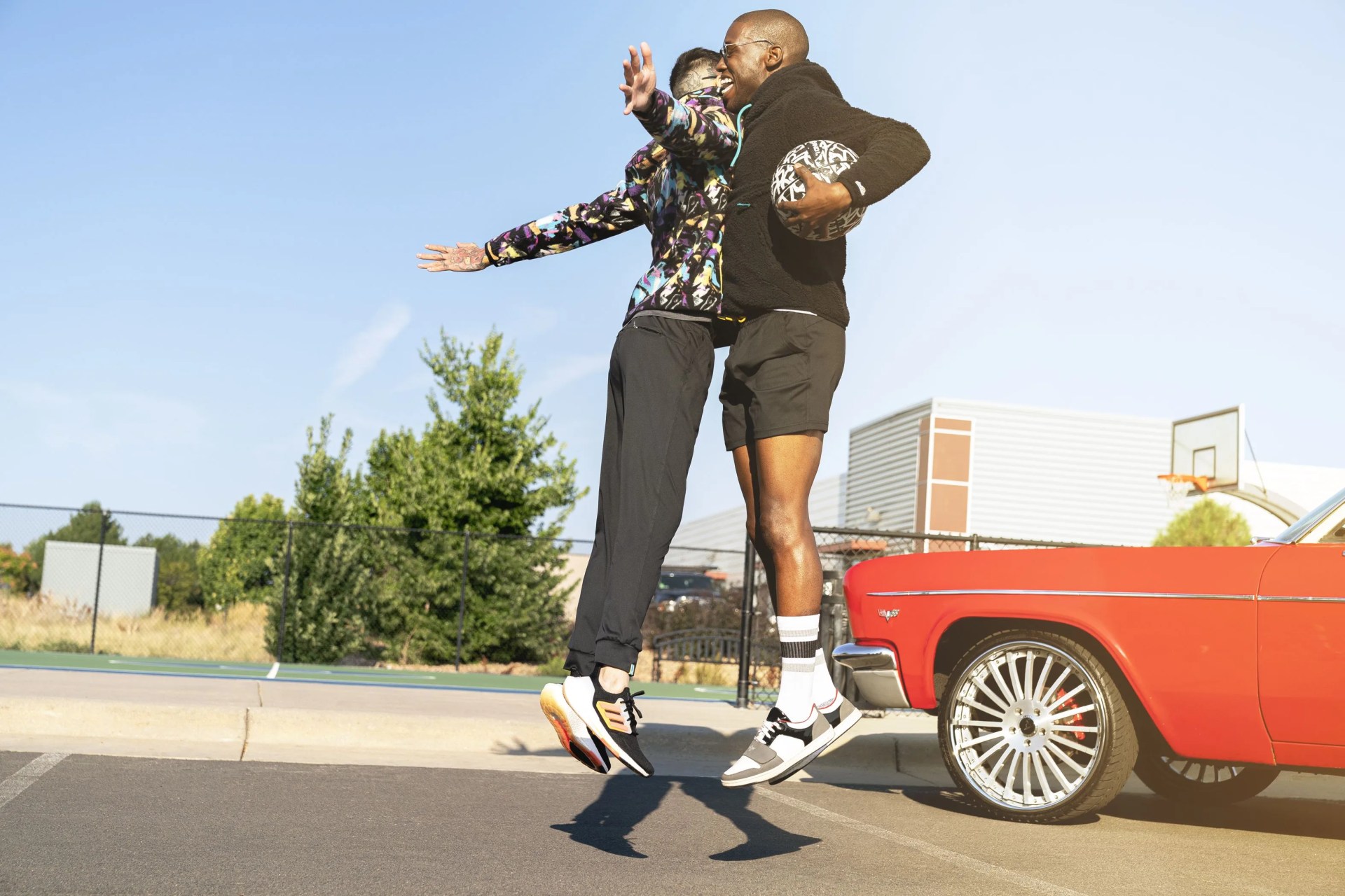 two men bumping chests in a parking lot