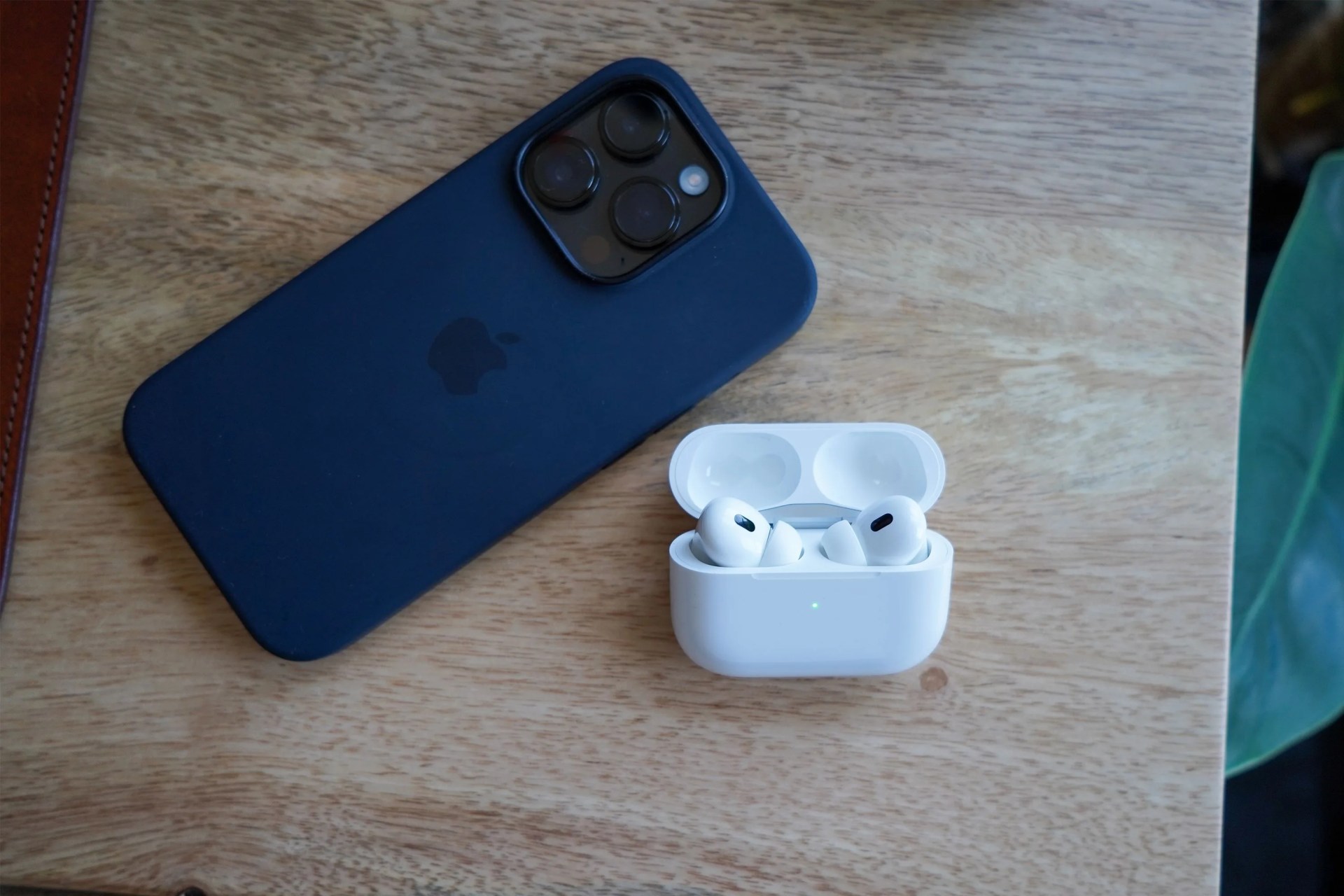 airpods 2 next to an iphone on a desk