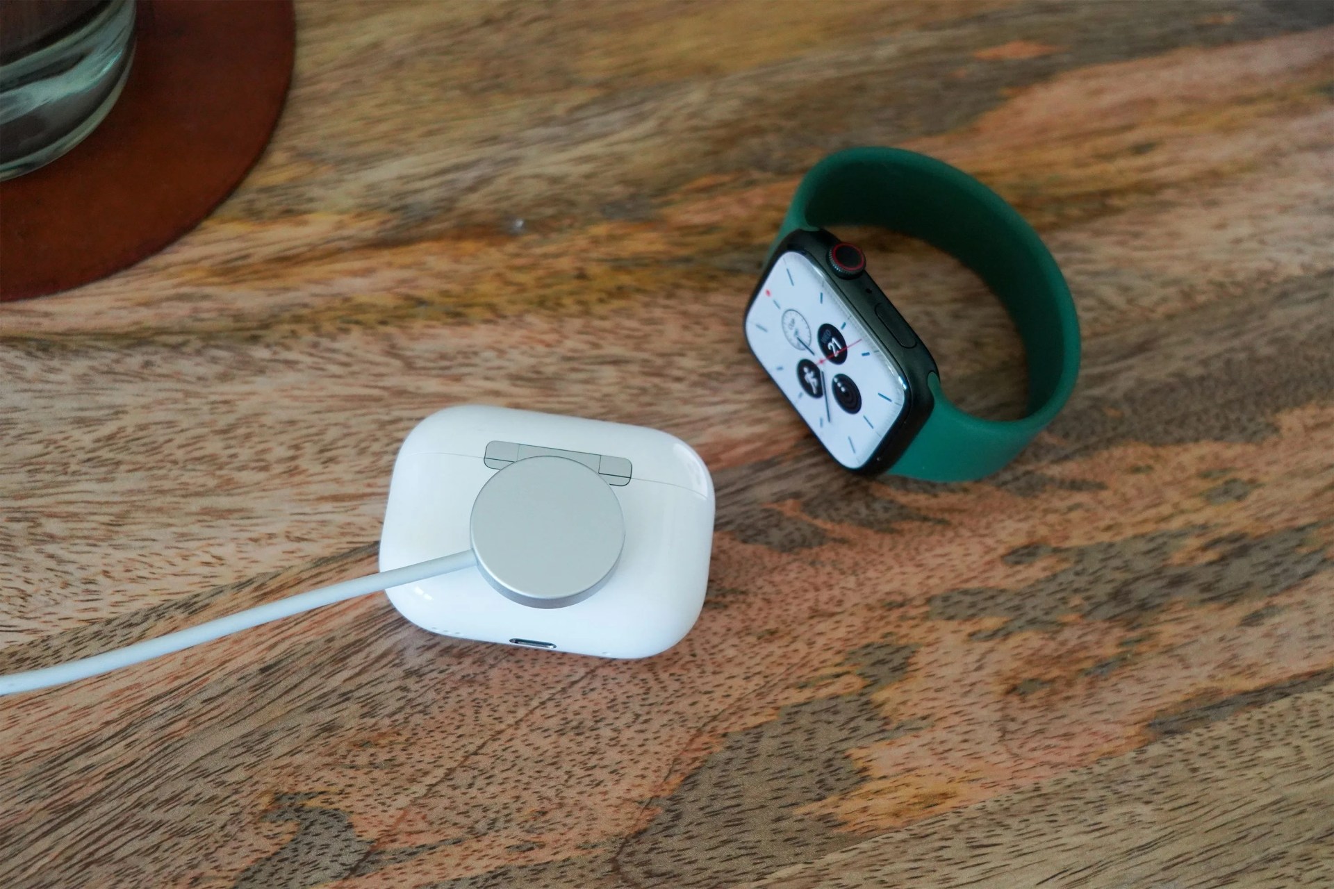 airpods 2 charging next to an apple watch on a desk