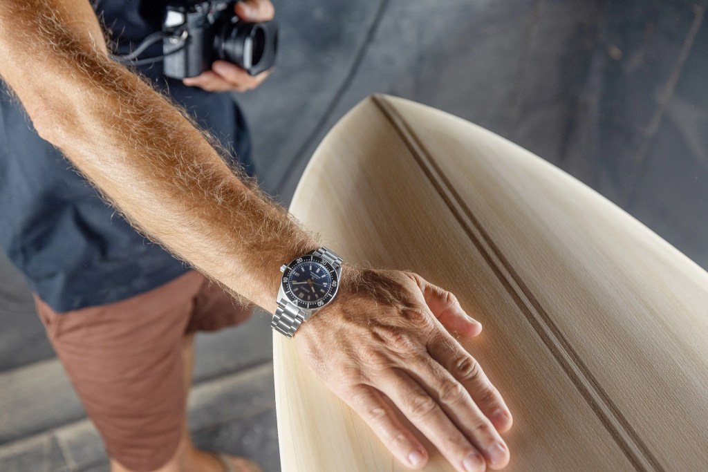 nick lavecchia wearing seiko watch with hand on surfboard