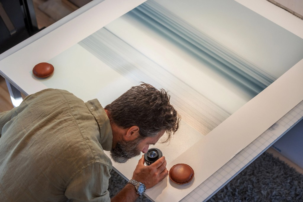 nick lavecchia wearing seiko watch looking closely at photo print
