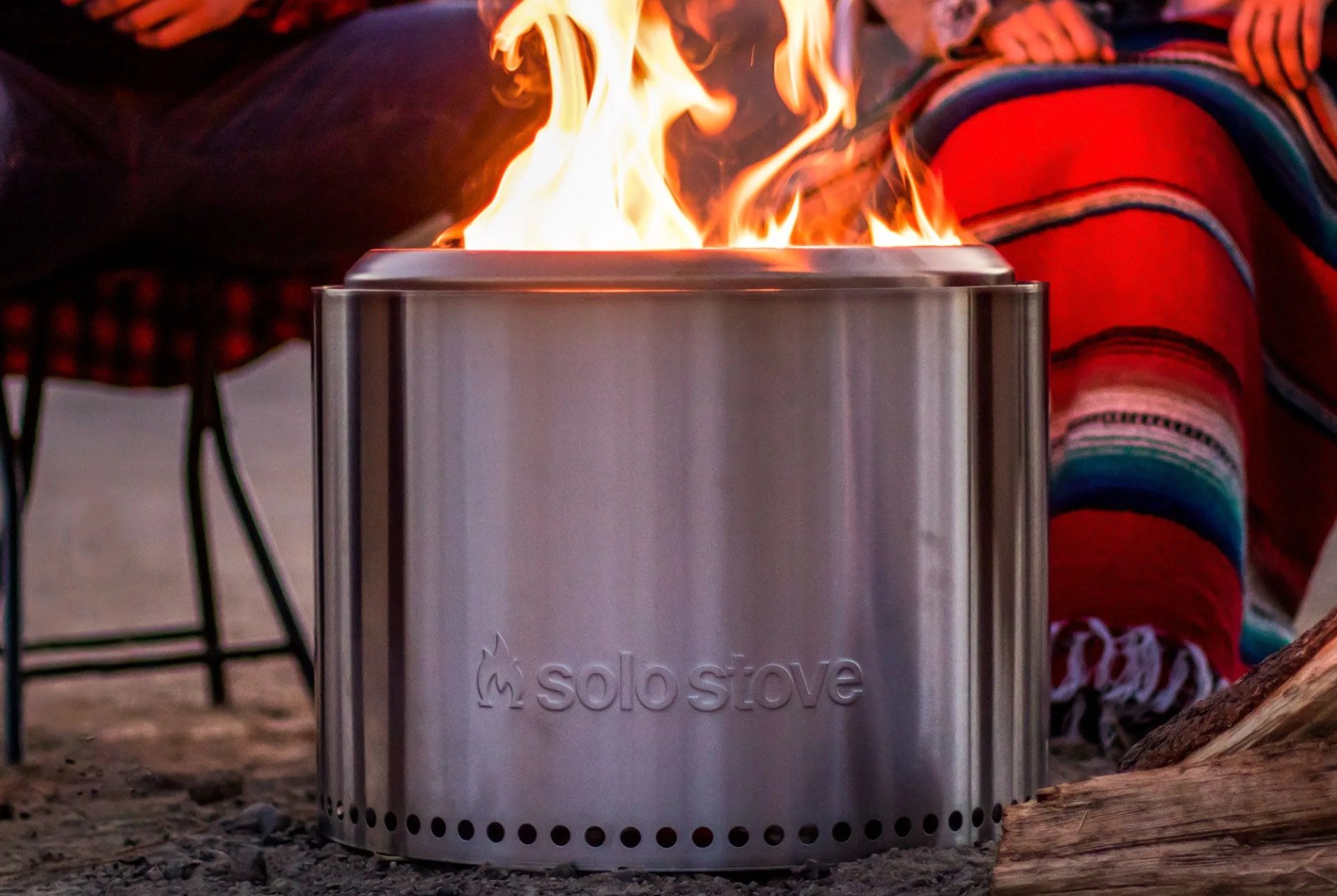 couple sitting around a solo stove fire pit