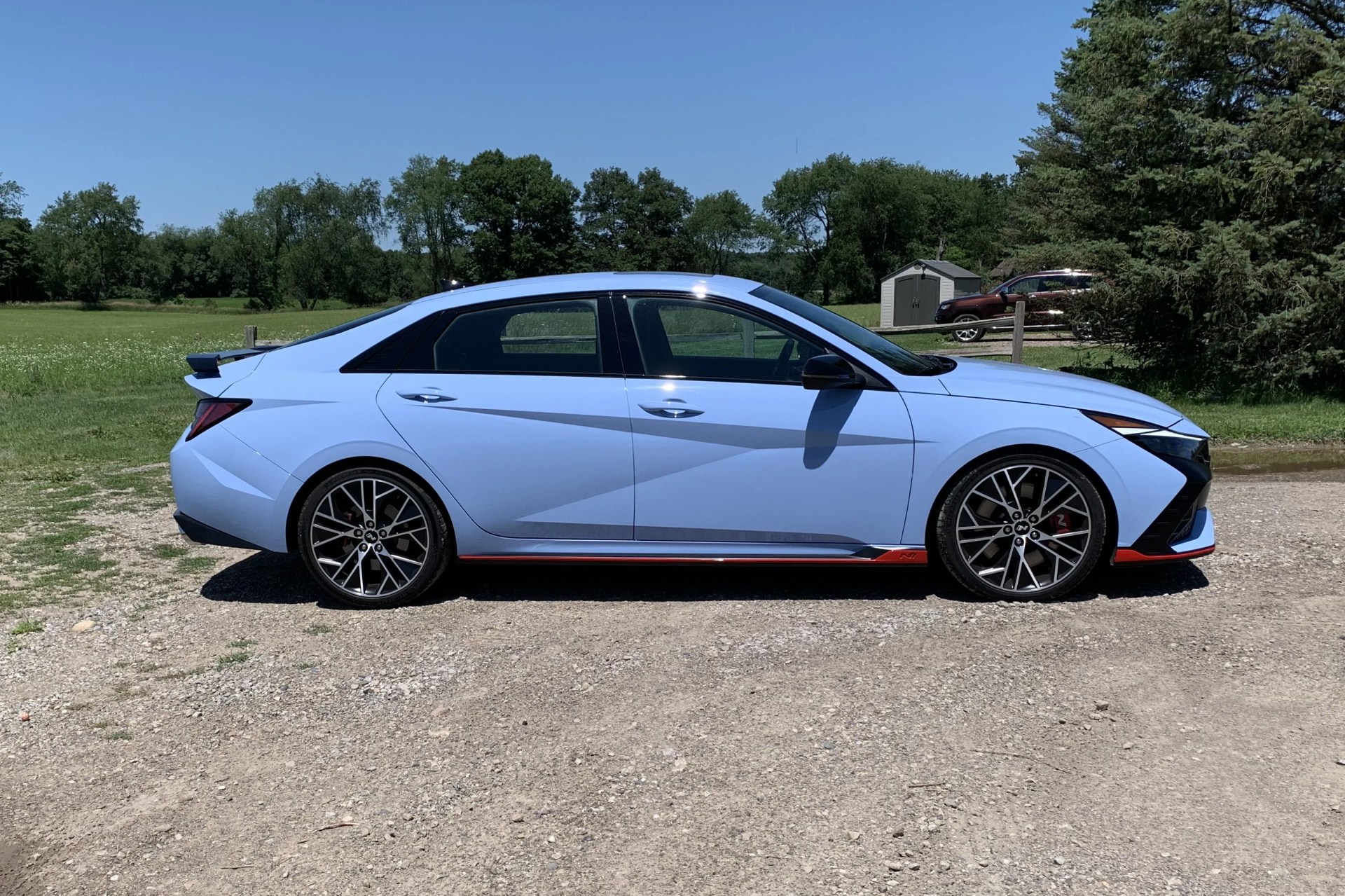 hyundai elantra n in front of a field