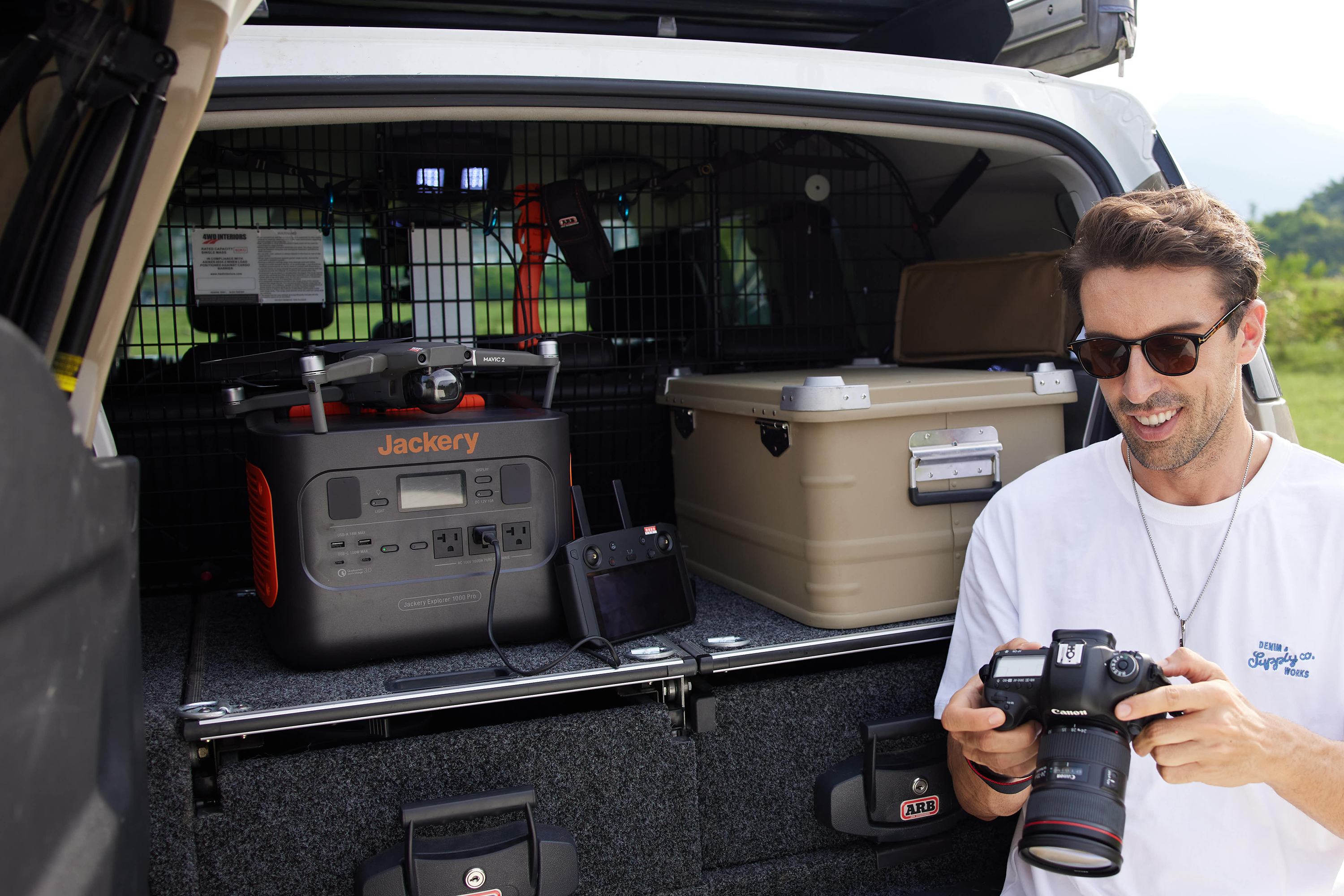 a jackery solar generator 1000 pro placed in the back of a truck charging a mavic drone