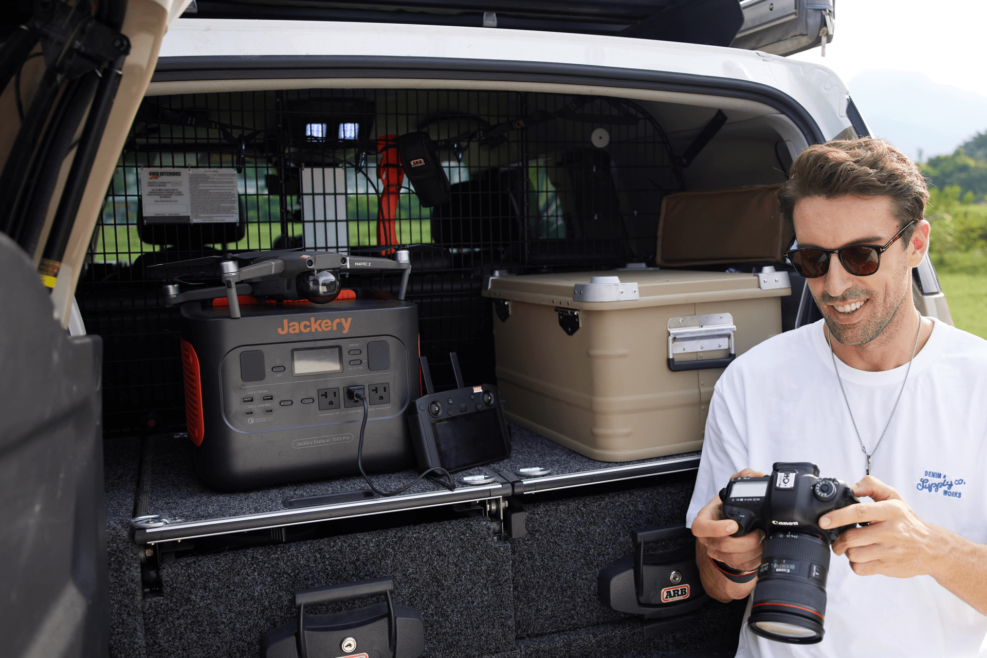 a jackery solar generator 1000 pro placed in the back of a truck charging a mavic drone