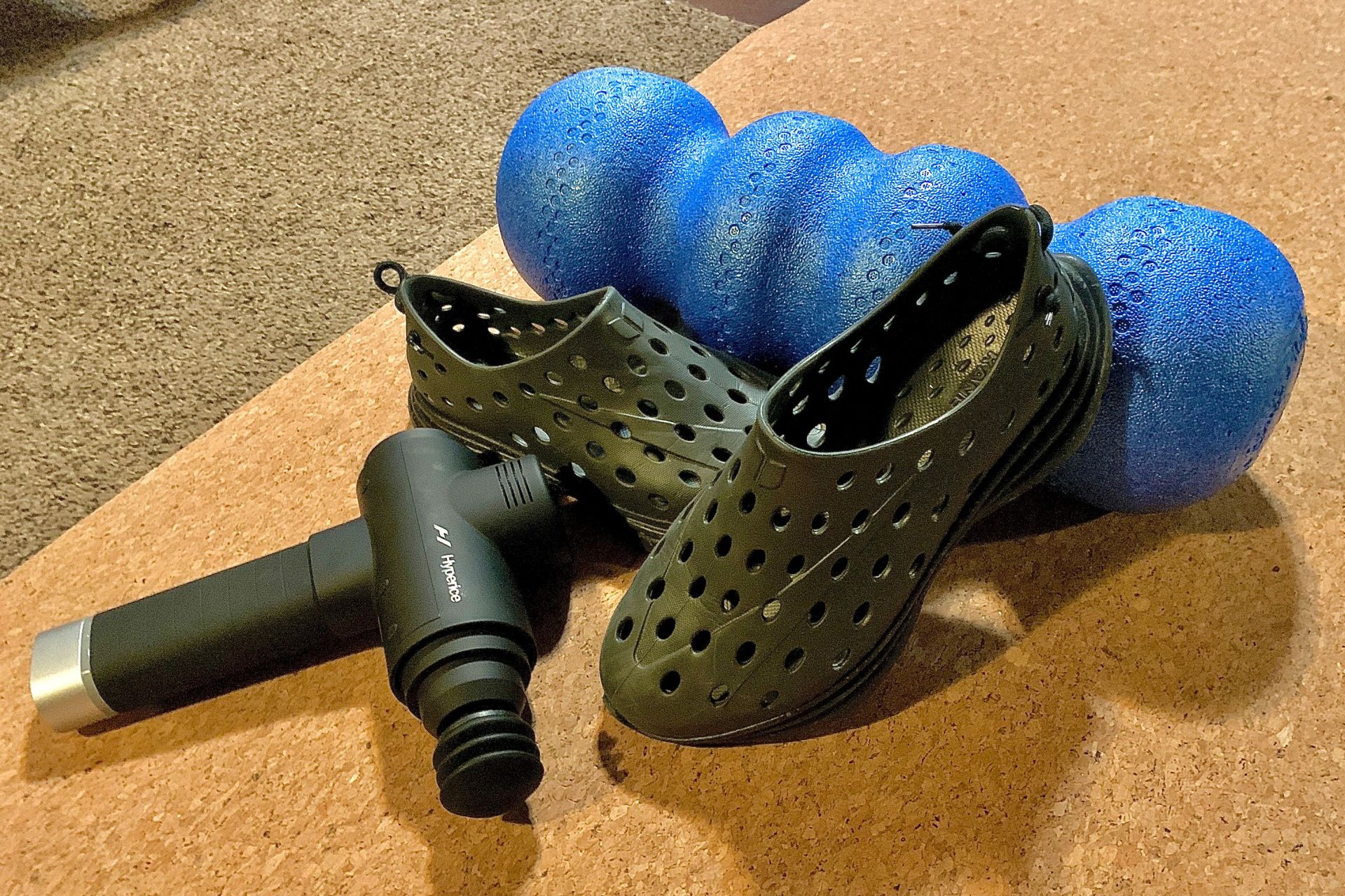 kane revive shoes on a workout mat next to a foam roller and hyperice gun