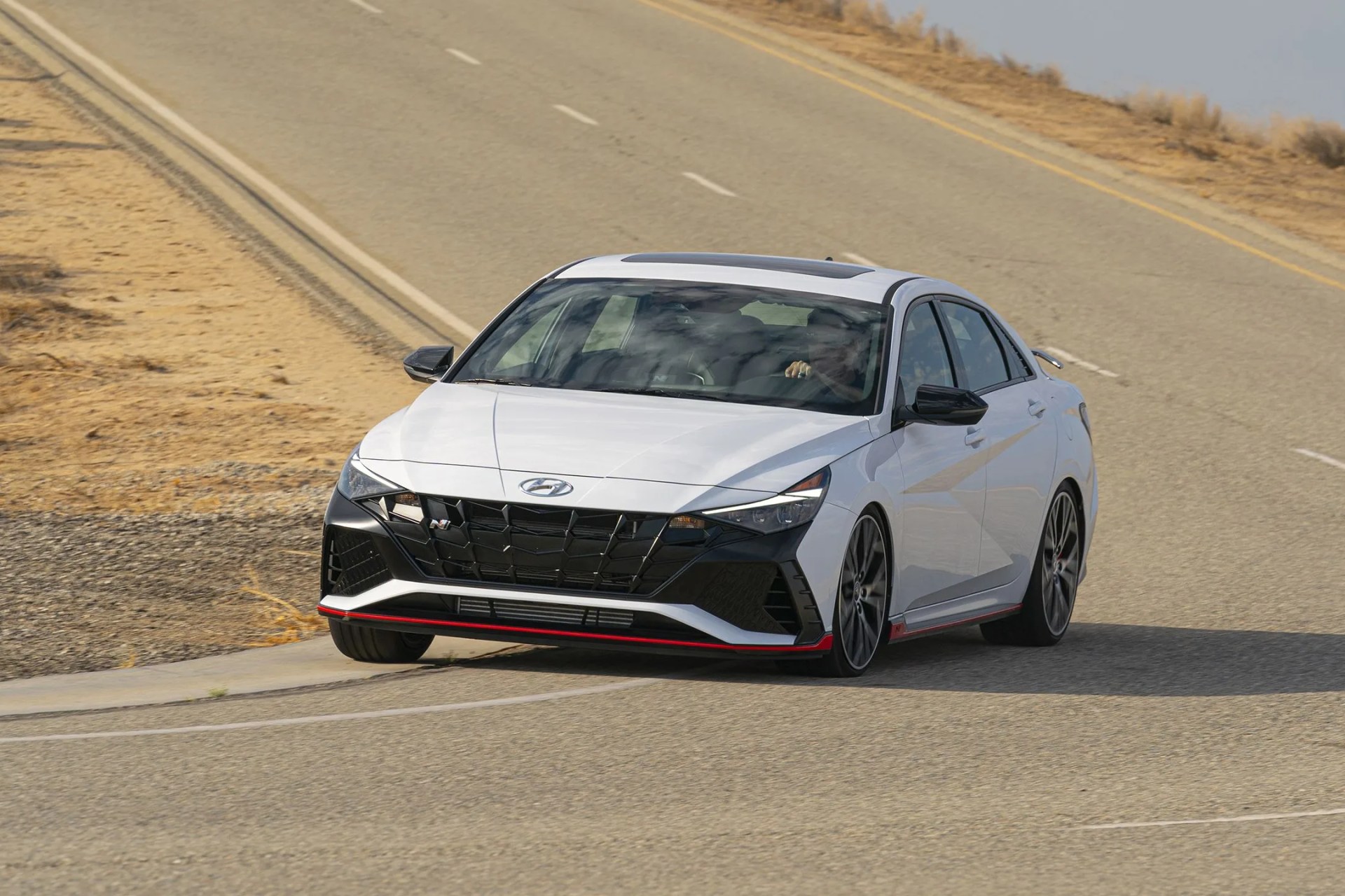 hyundai elantra n tackling a sharp downhill right hand turn in the desert