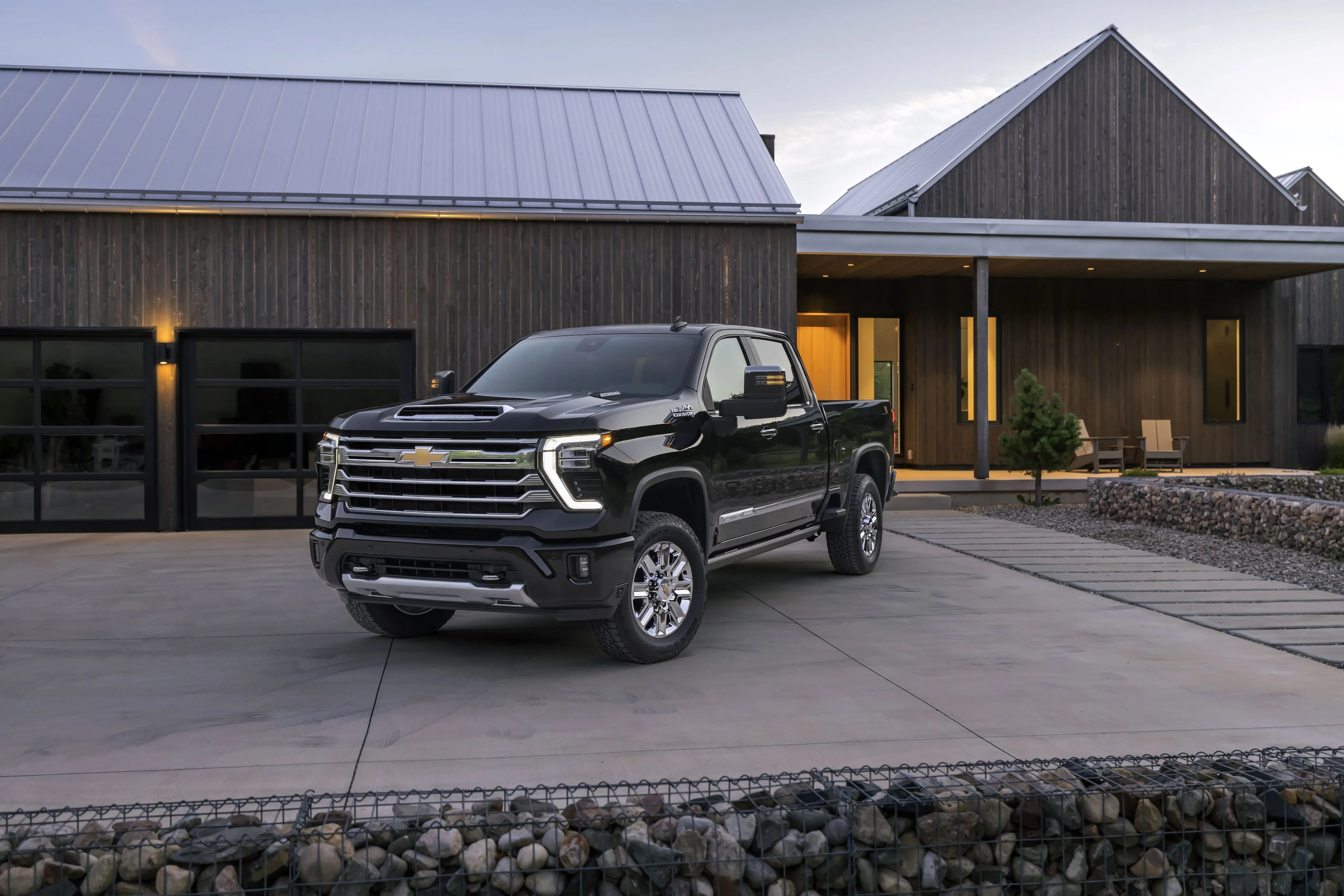 chevrolet silverado hd parked in front of wood house