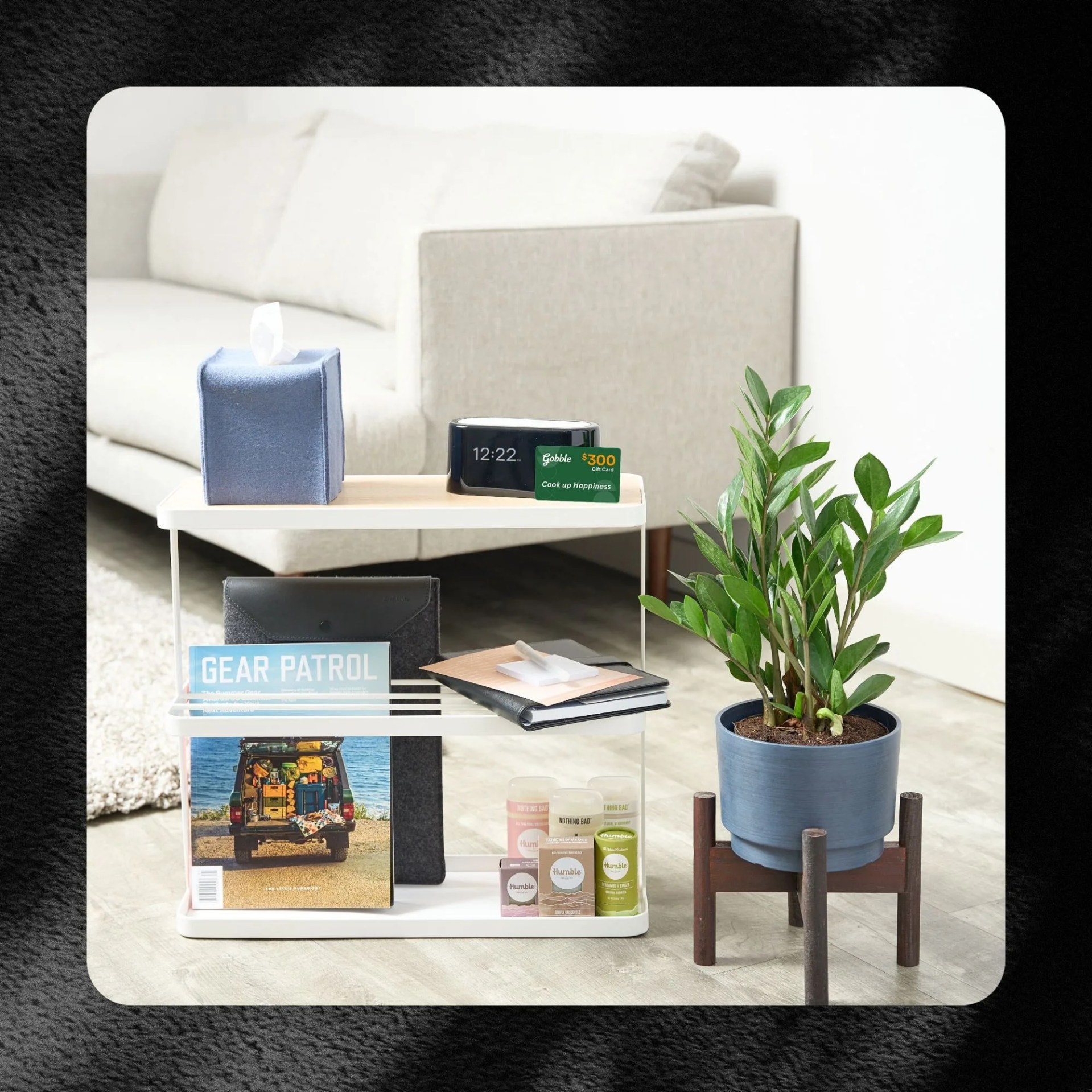 gear patrol magazine, bumble products, a plant, gobble $300 gift card, clock prizes in a living room
