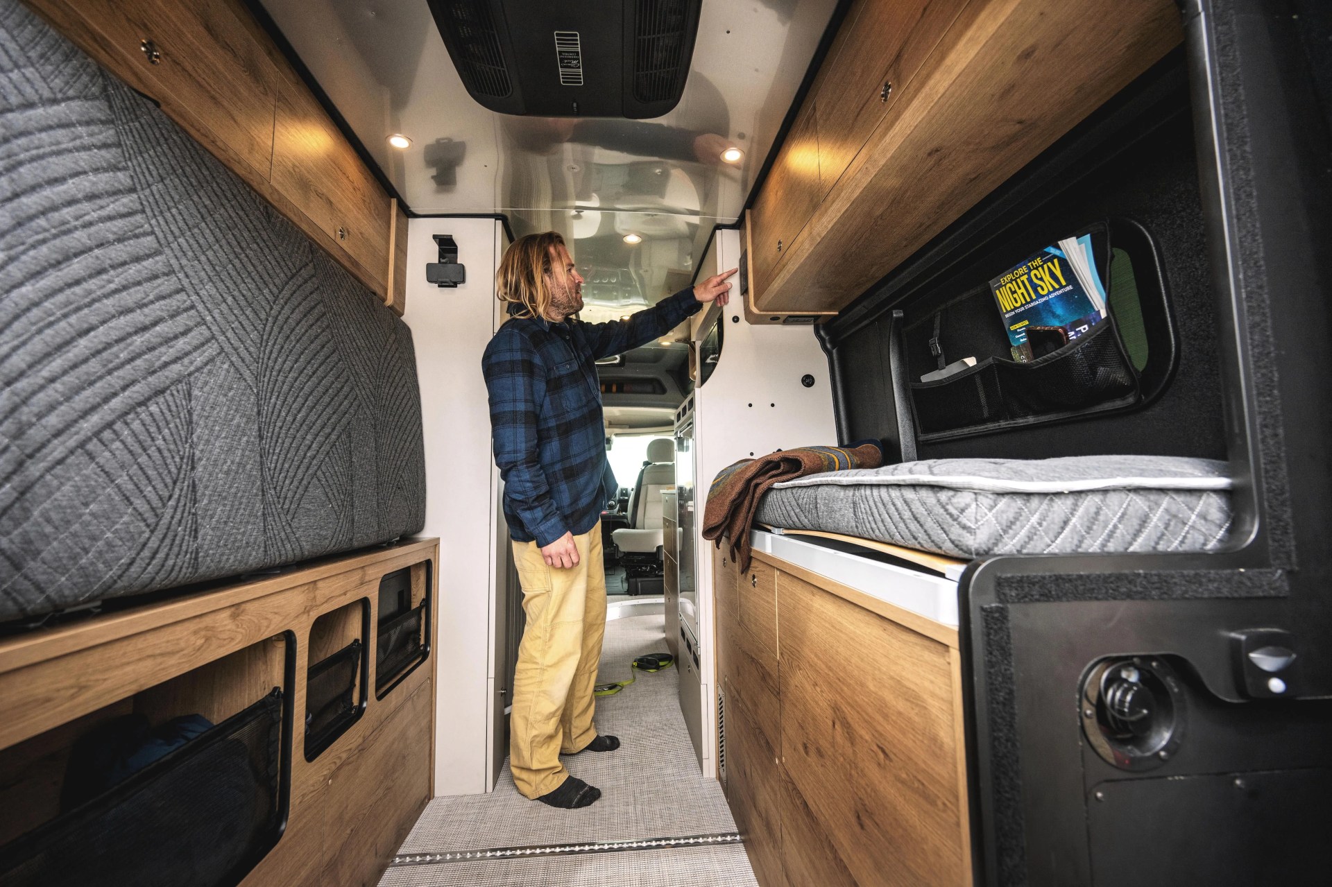 long haired man in airstream rangeline interior