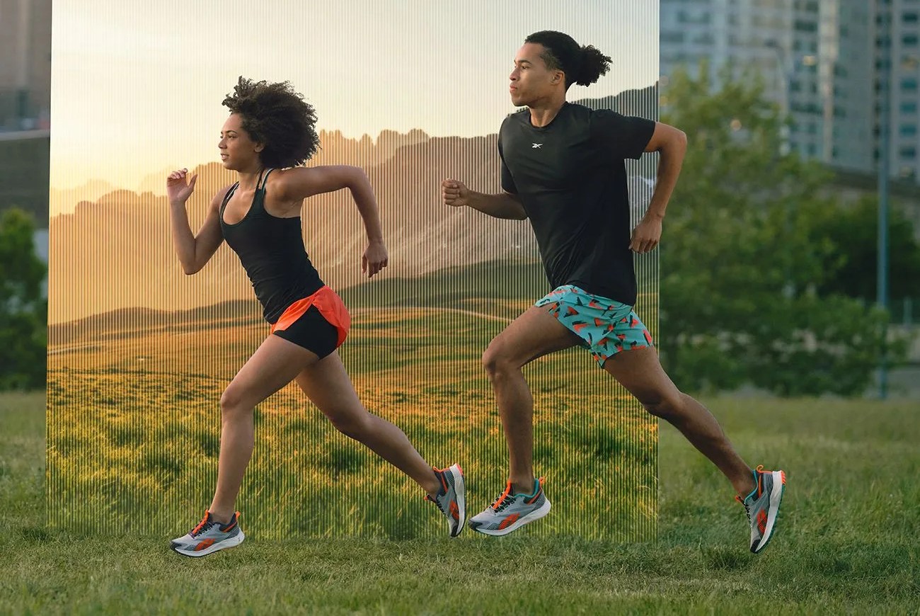 two people running on grass
